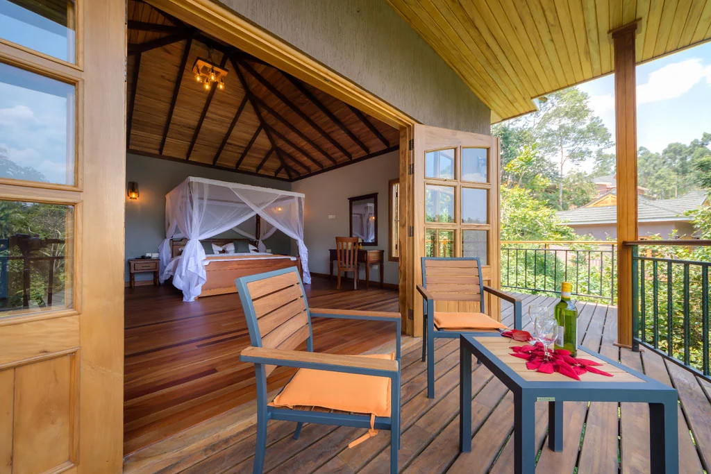 A cottage veranda with chairs and the bedroom beyond