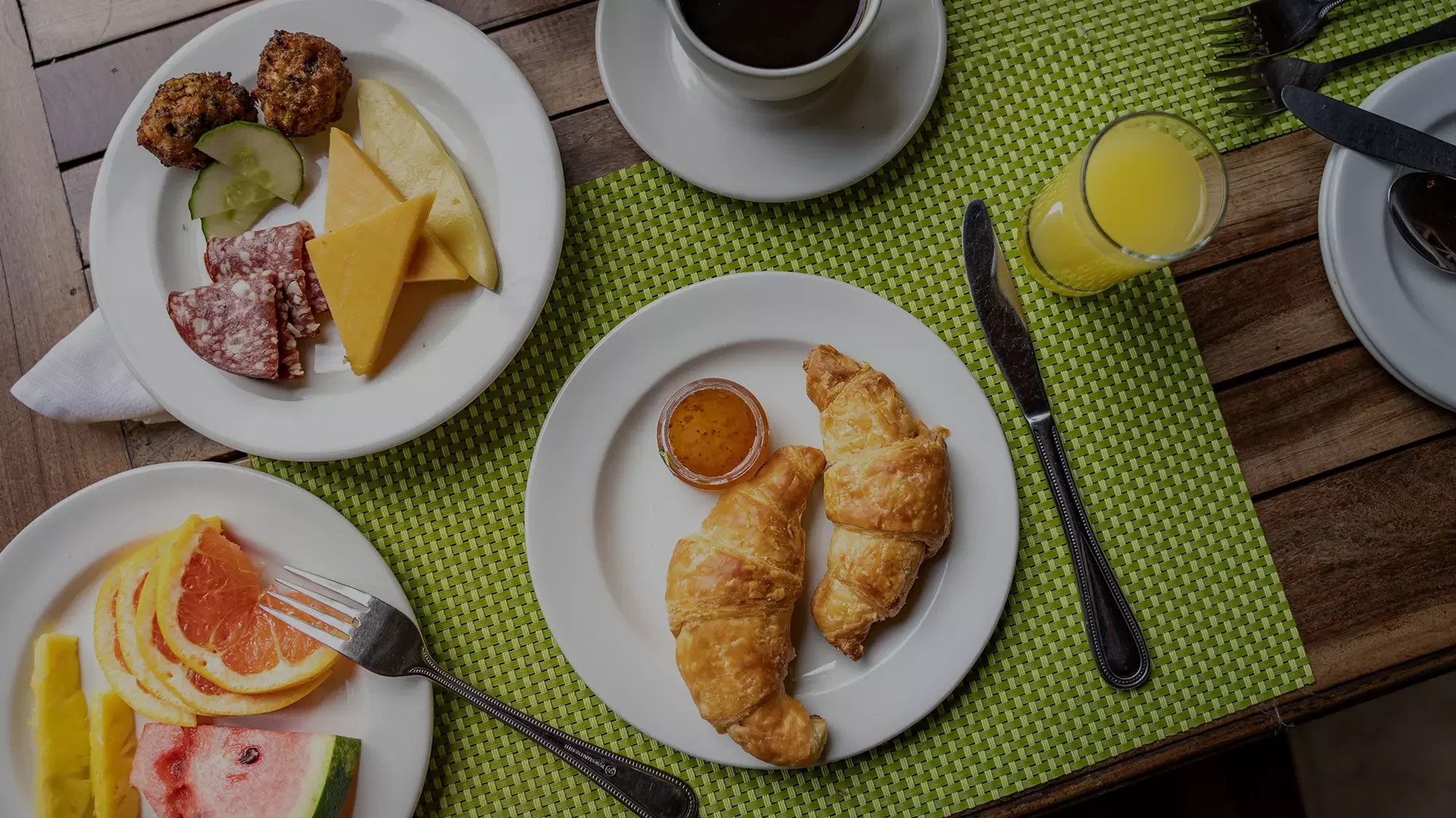 Breakfast plates with croissants and fruit