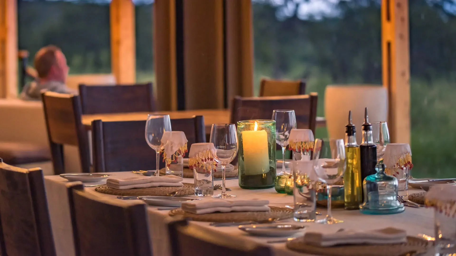 The dining table laid with glasses and candles