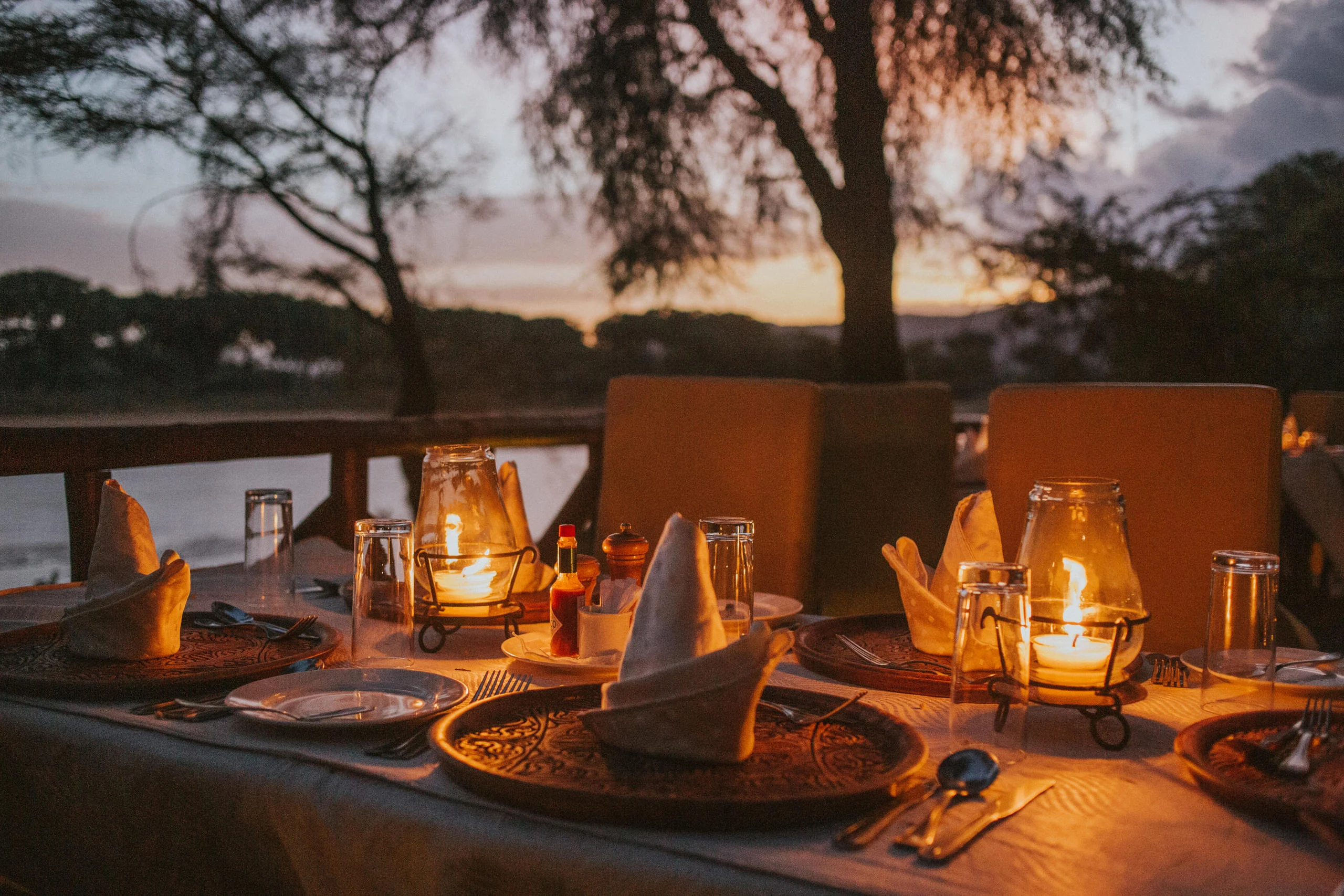 Lanterns on a dinner table at sunset