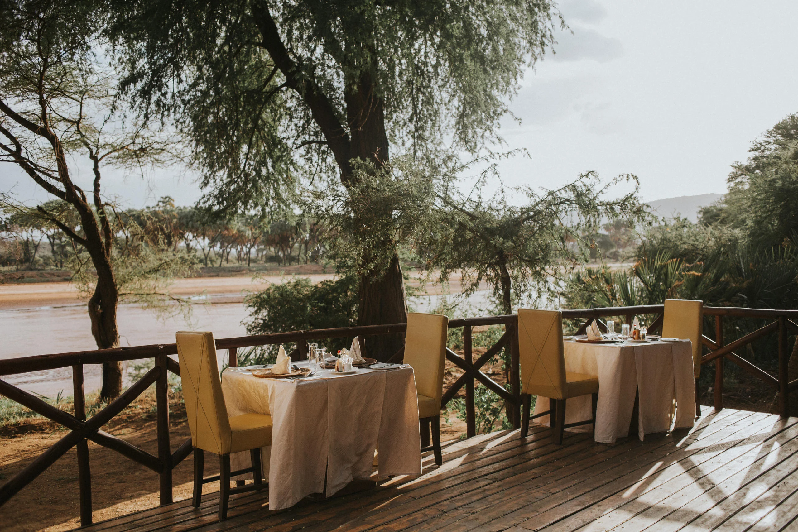 A table set on a deck above the river