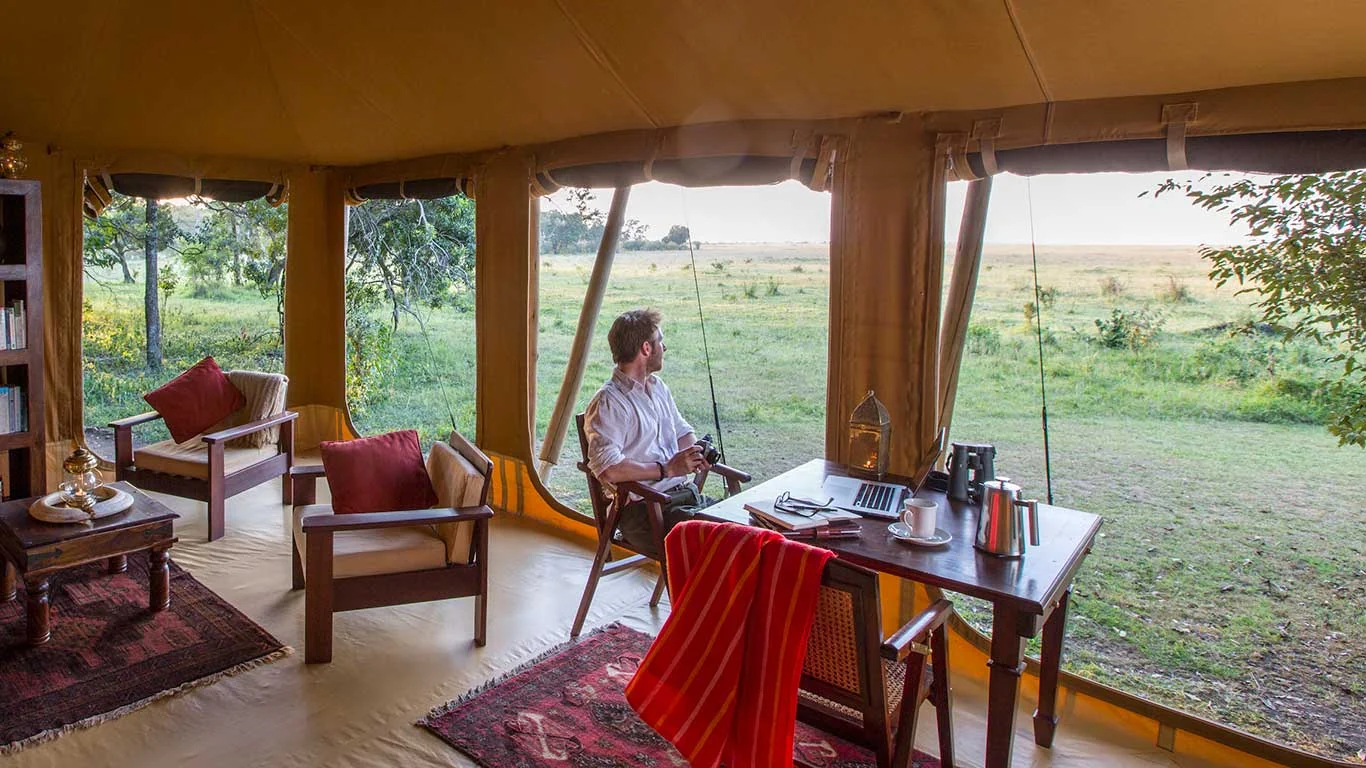 A guest at breakfast in a tent