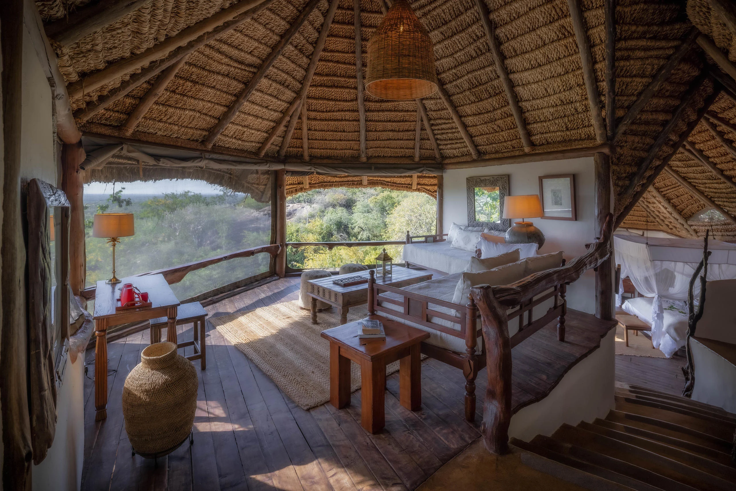 A cottage sitting room with windows onto the plains