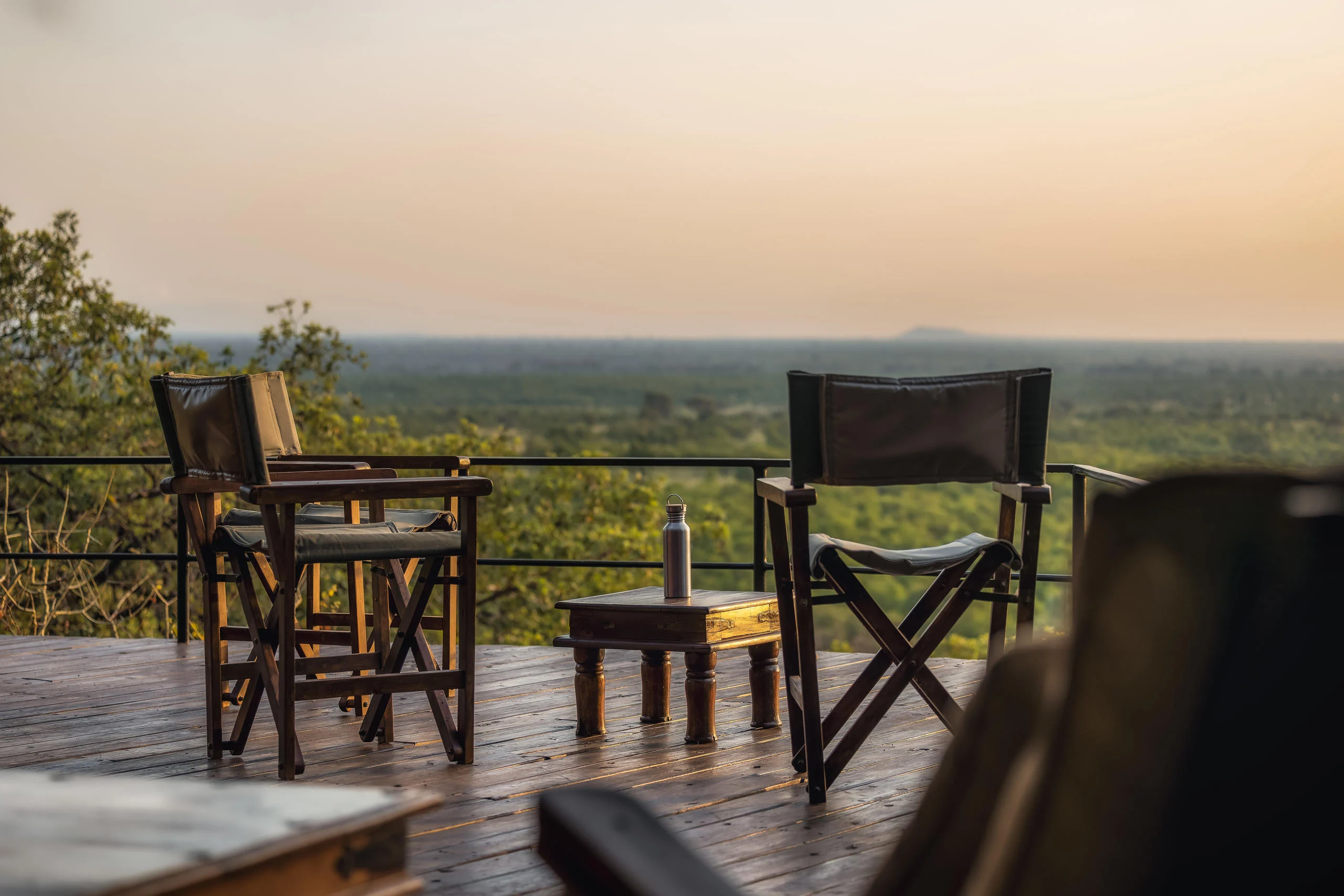 Chairs on a deck looking over the plains at dusk