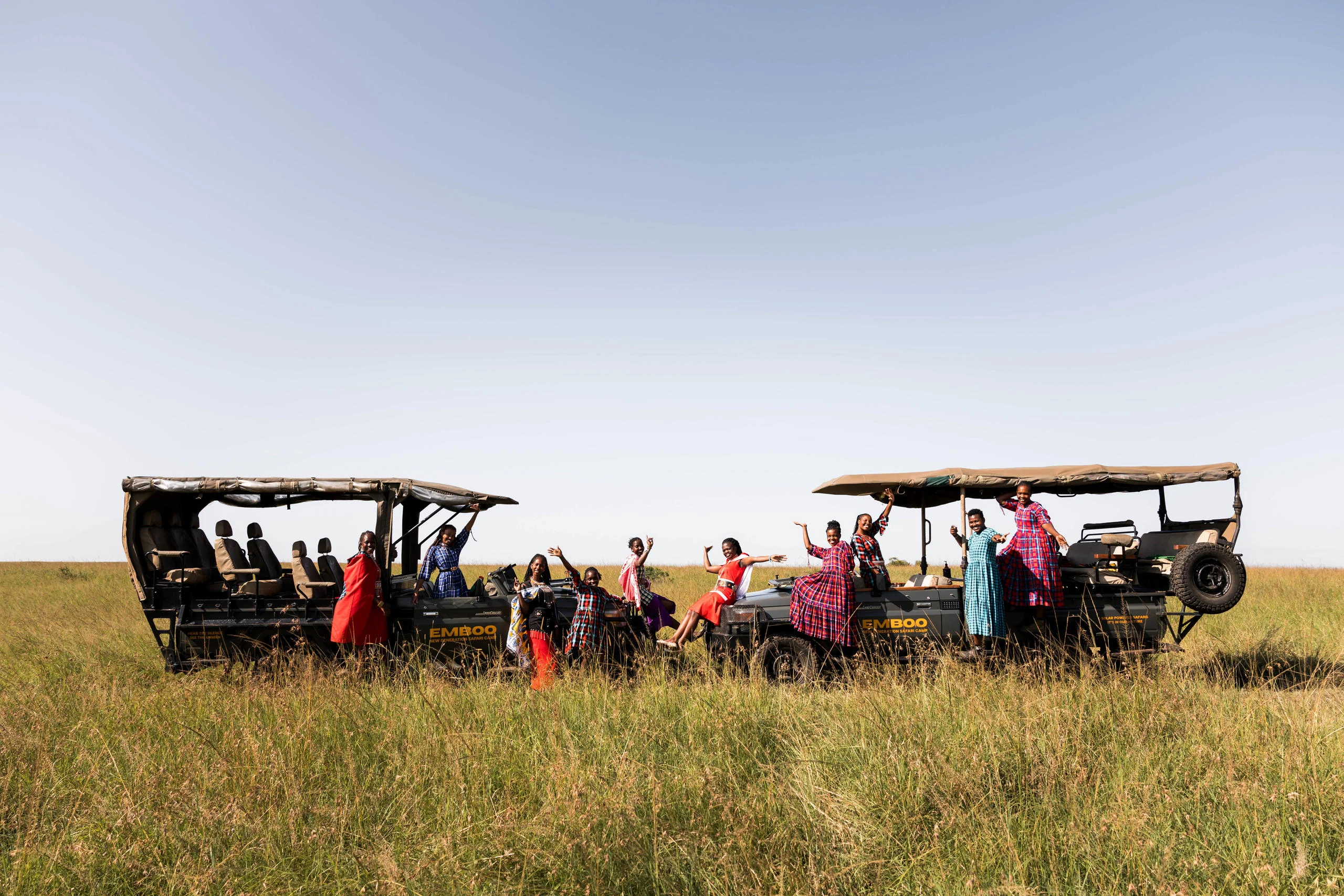 Guests in electric safari vehicles on the plains