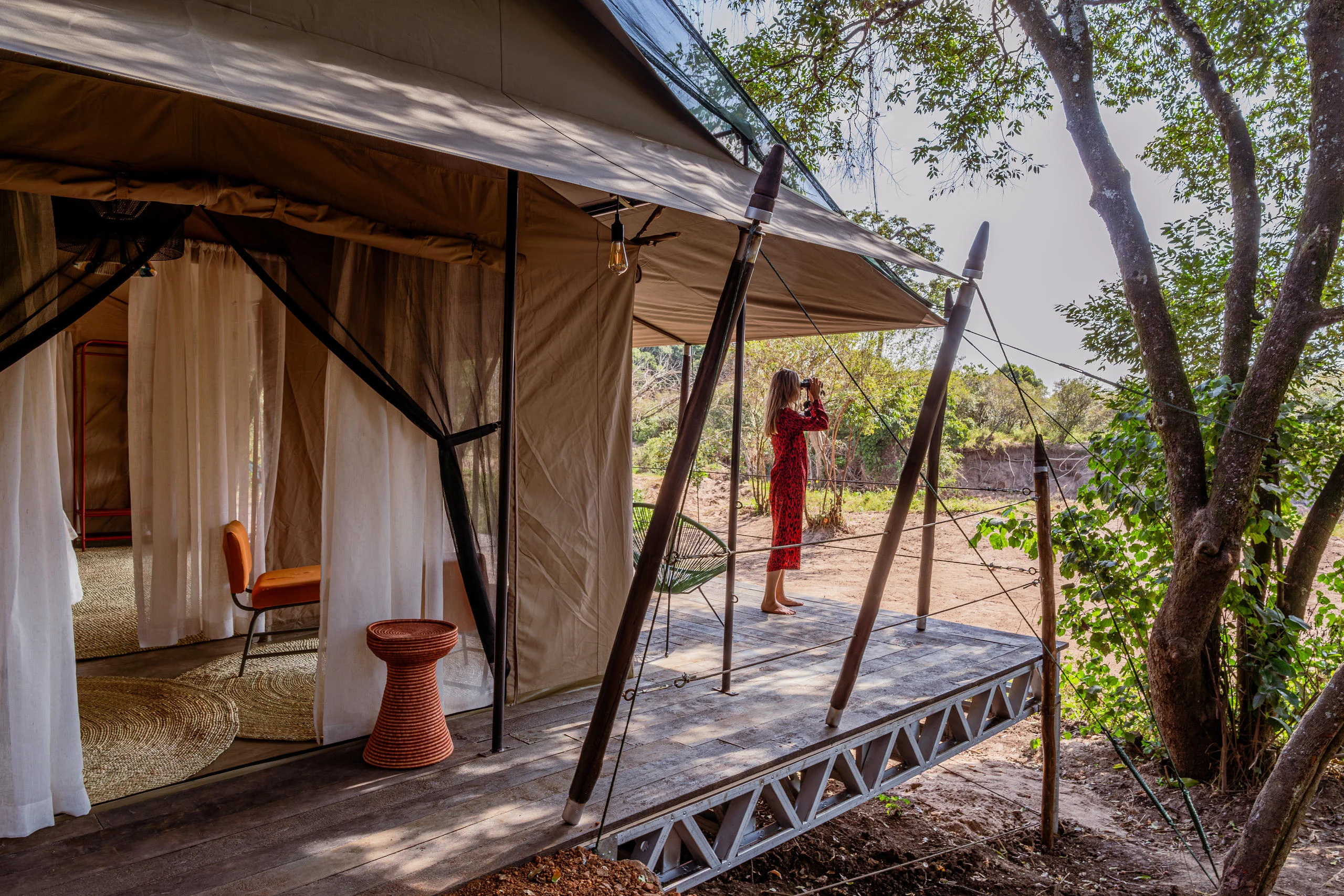A guest tent with its deck among the trees