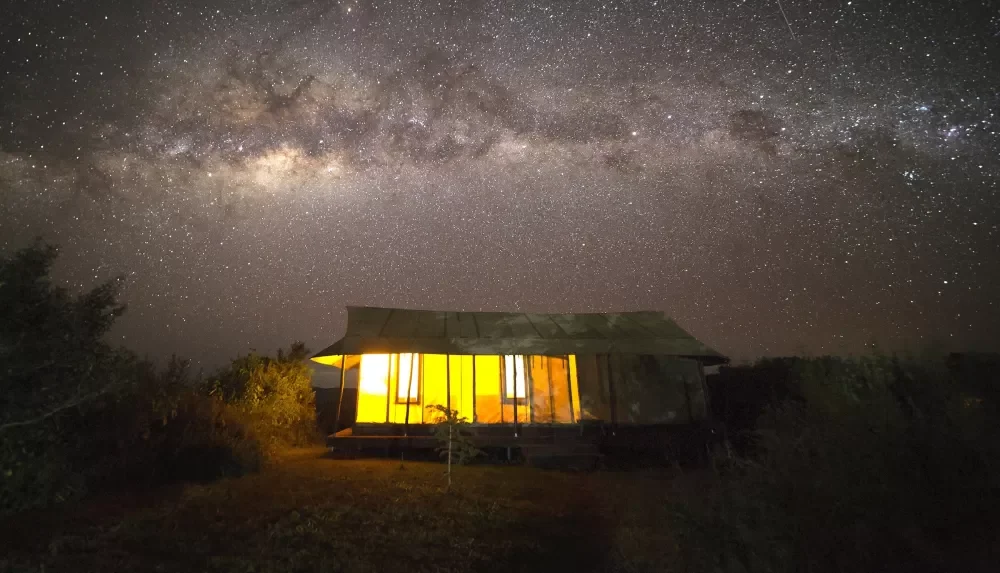 A lit guest room under the night sky