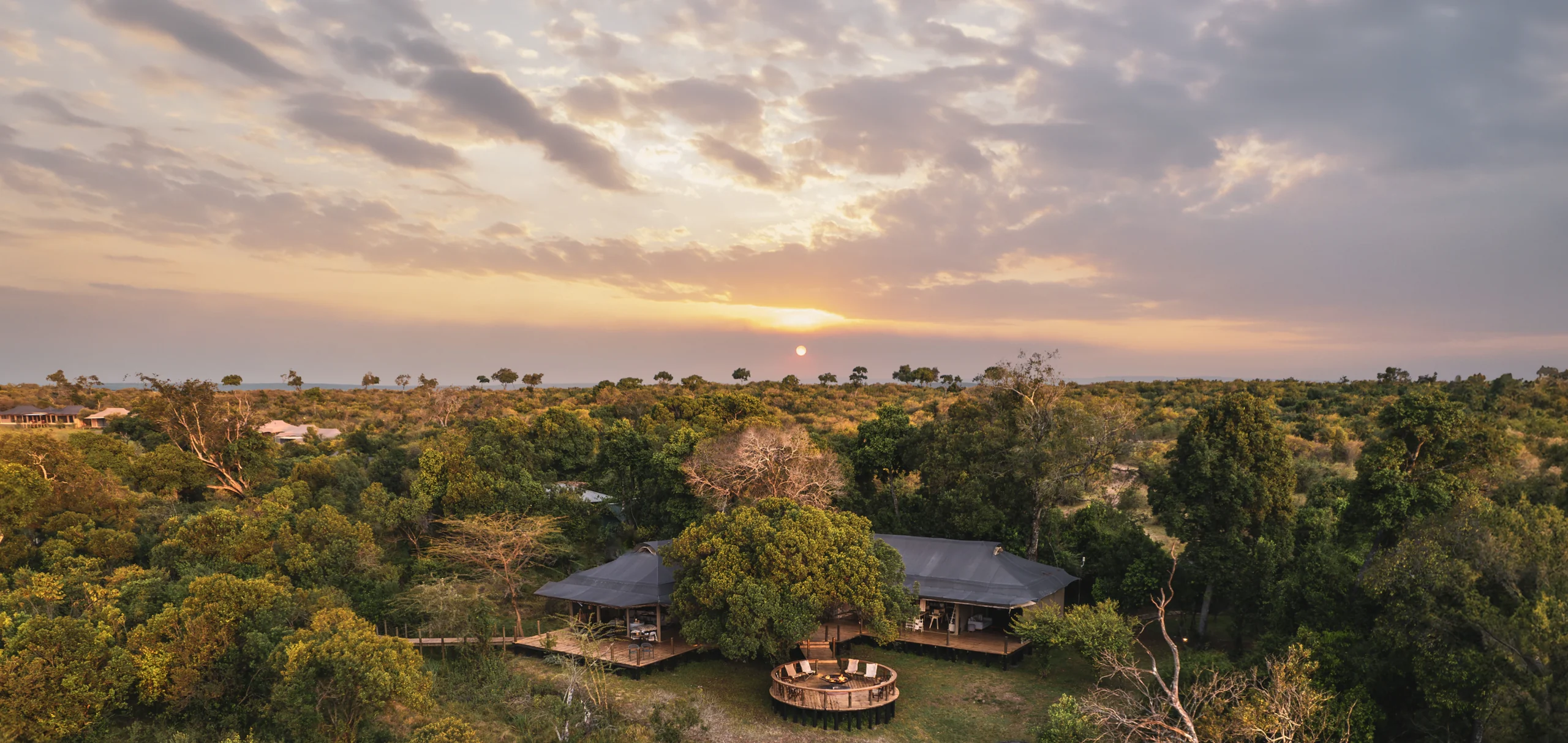 The camp among the trees at sunset, from the air