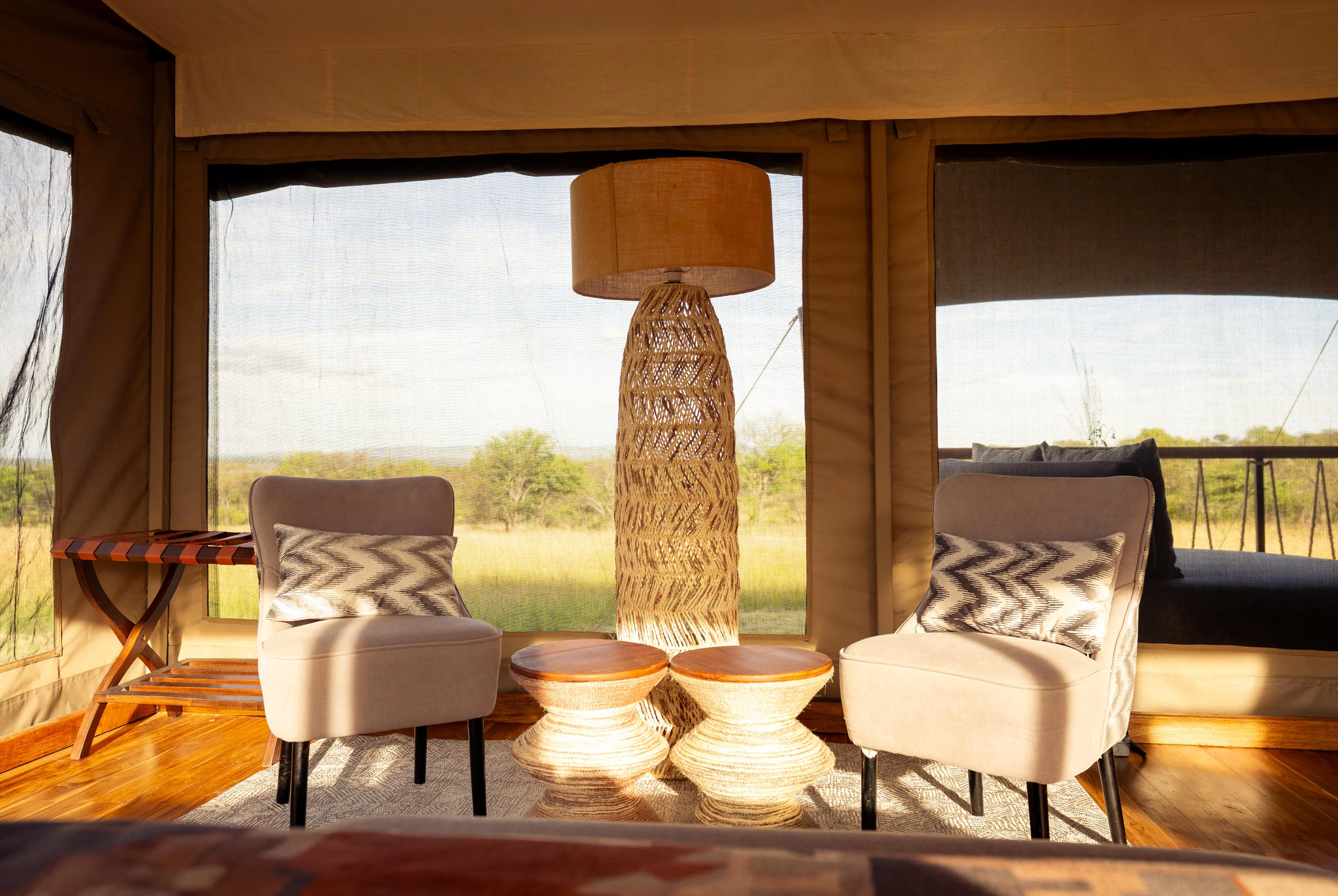 Armchairs in a tent with the plains beyond