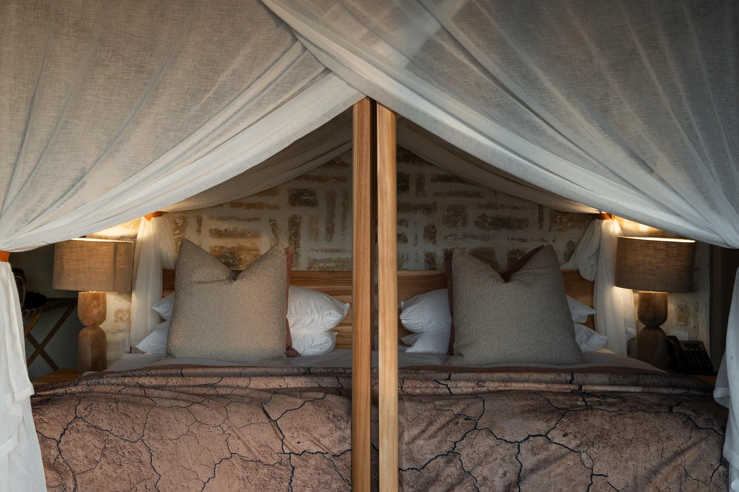 A canopied bed with cushions