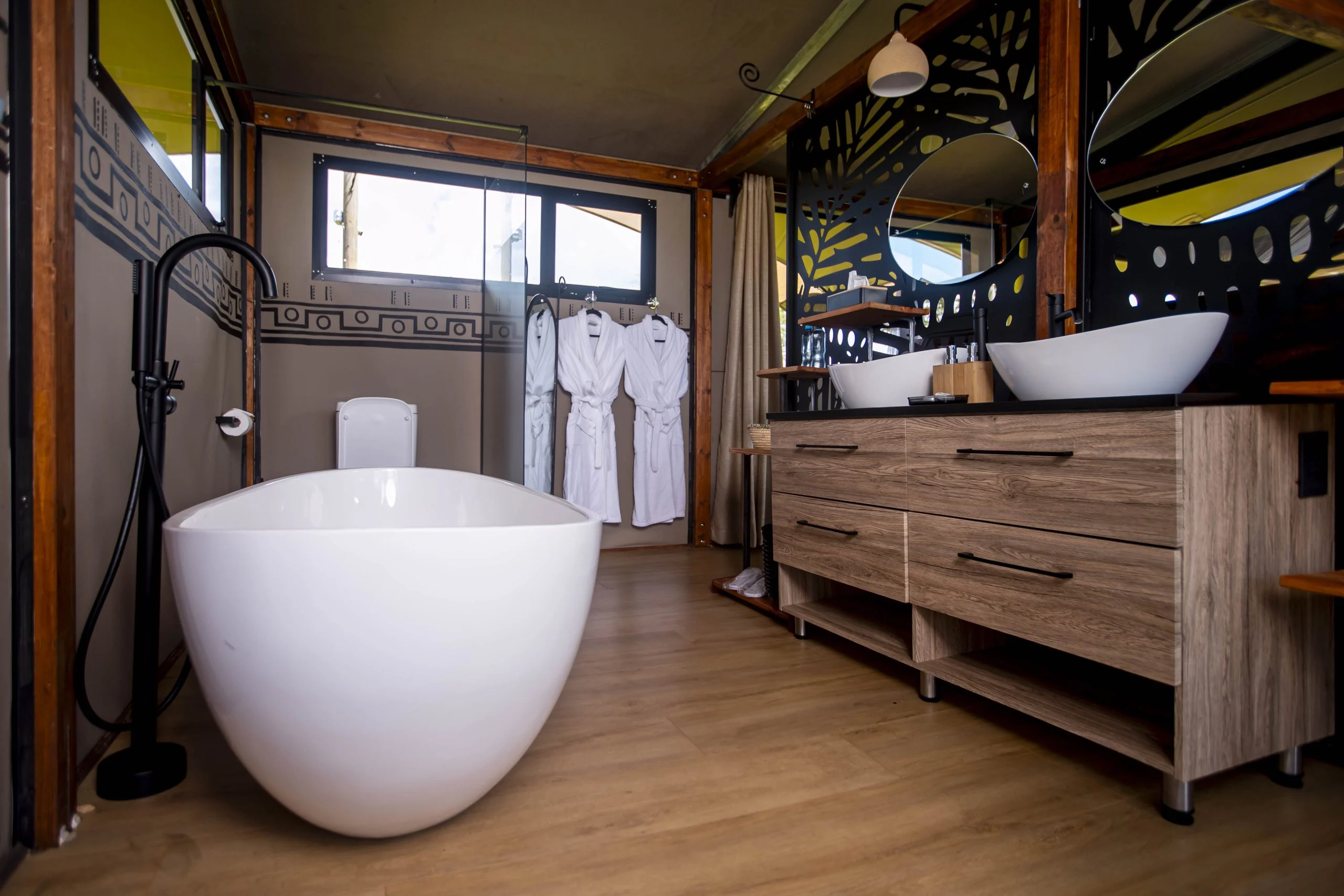 A freestanding bath beside the window