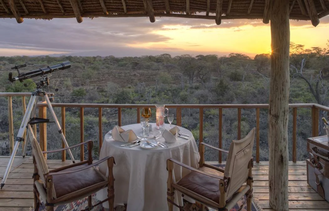 A table and telescope on the observation deck at sunset