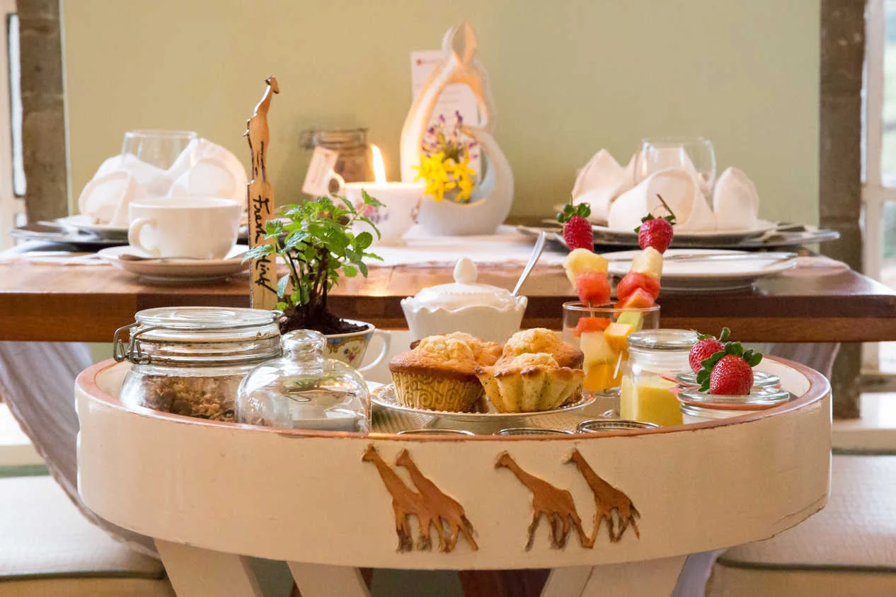 A breakfast tray of pastries and fruit decorated with giraffe figures