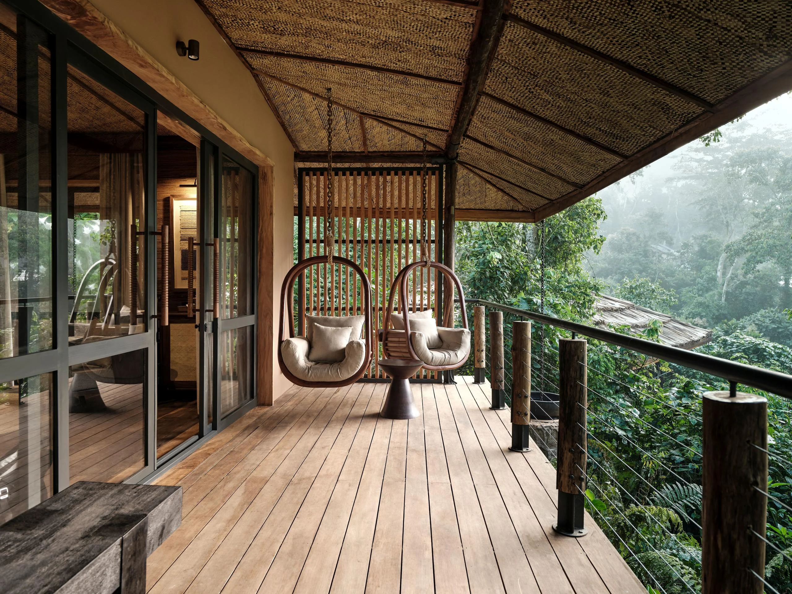 Hanging chairs on a deck above the forest