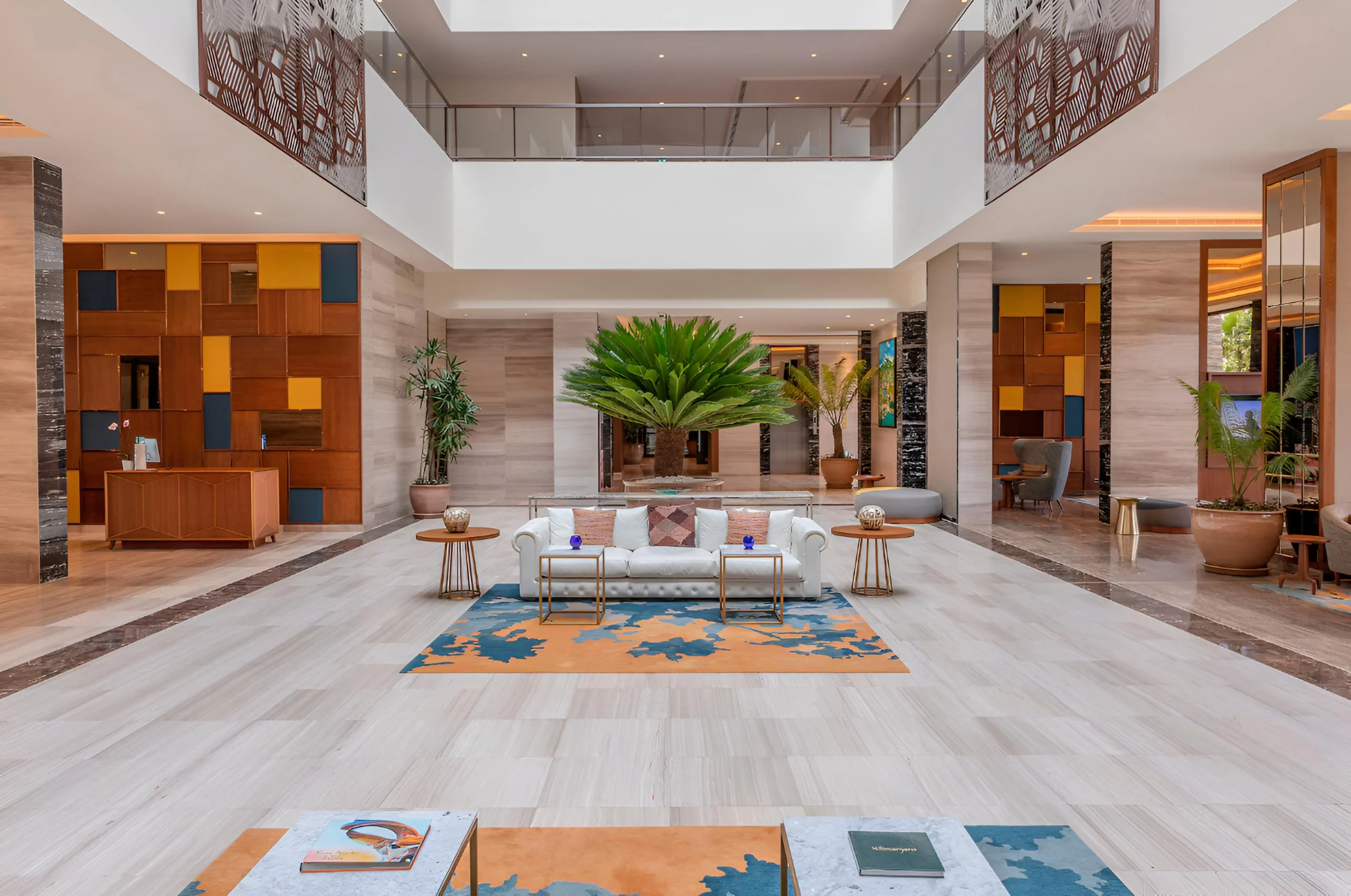 The lobby with a high ceiling and patterned rug