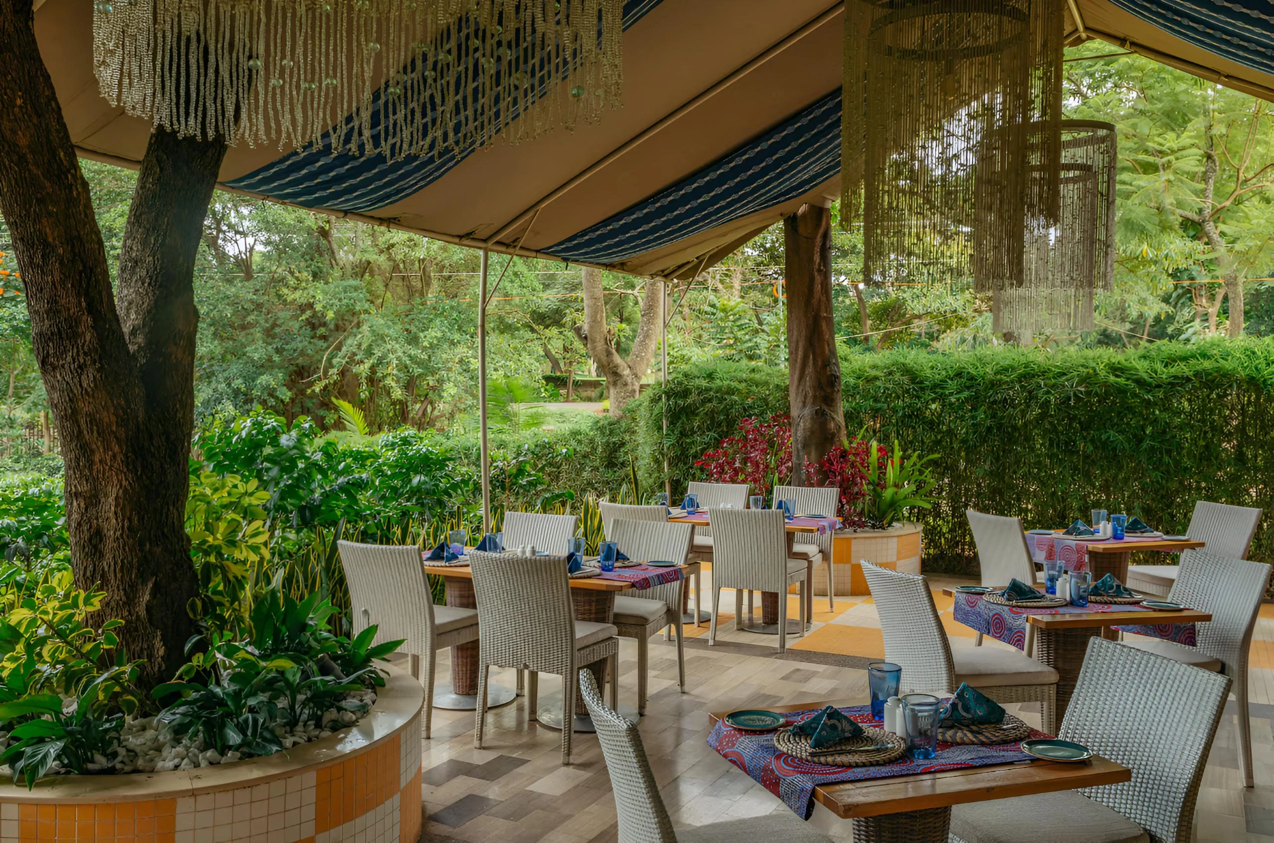 Tables beneath the trees in the garden restaurant