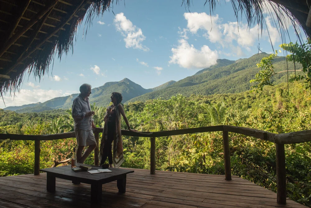 Two guests on the deck looking towards the mountains