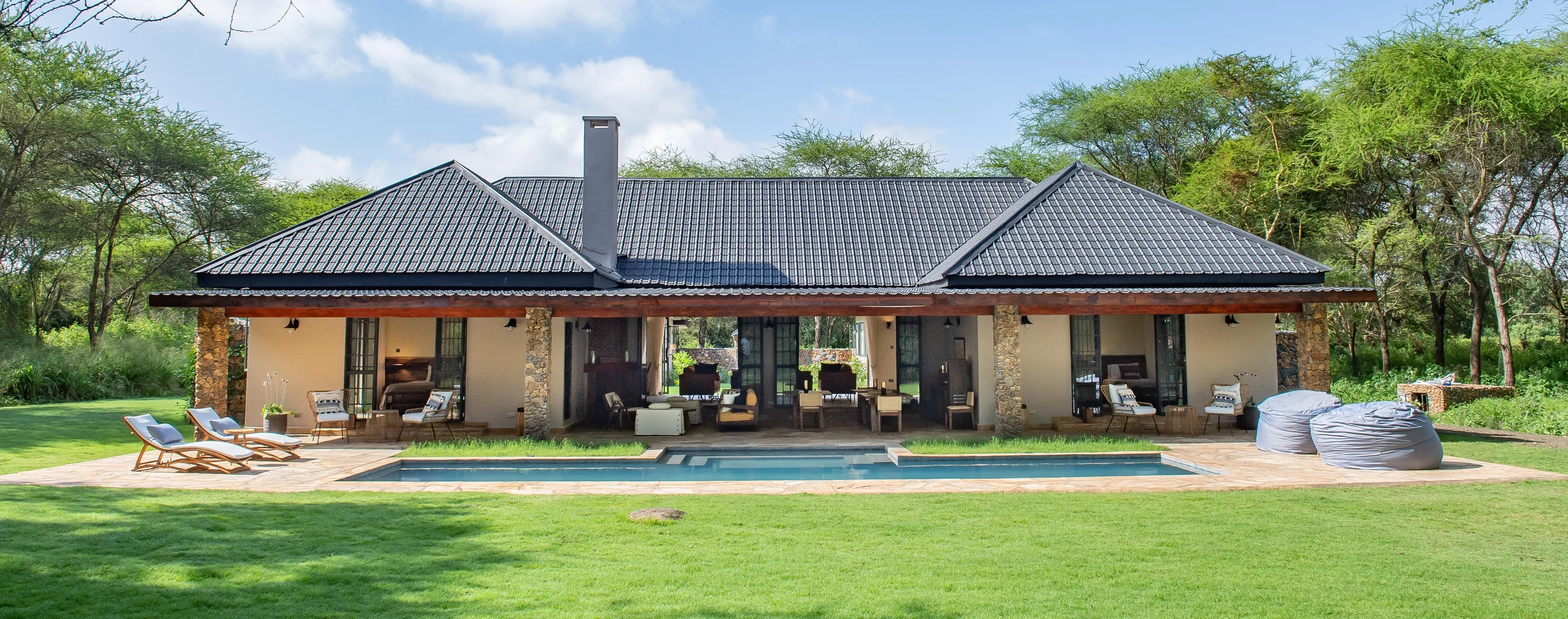 The house and pool seen across the lawn
