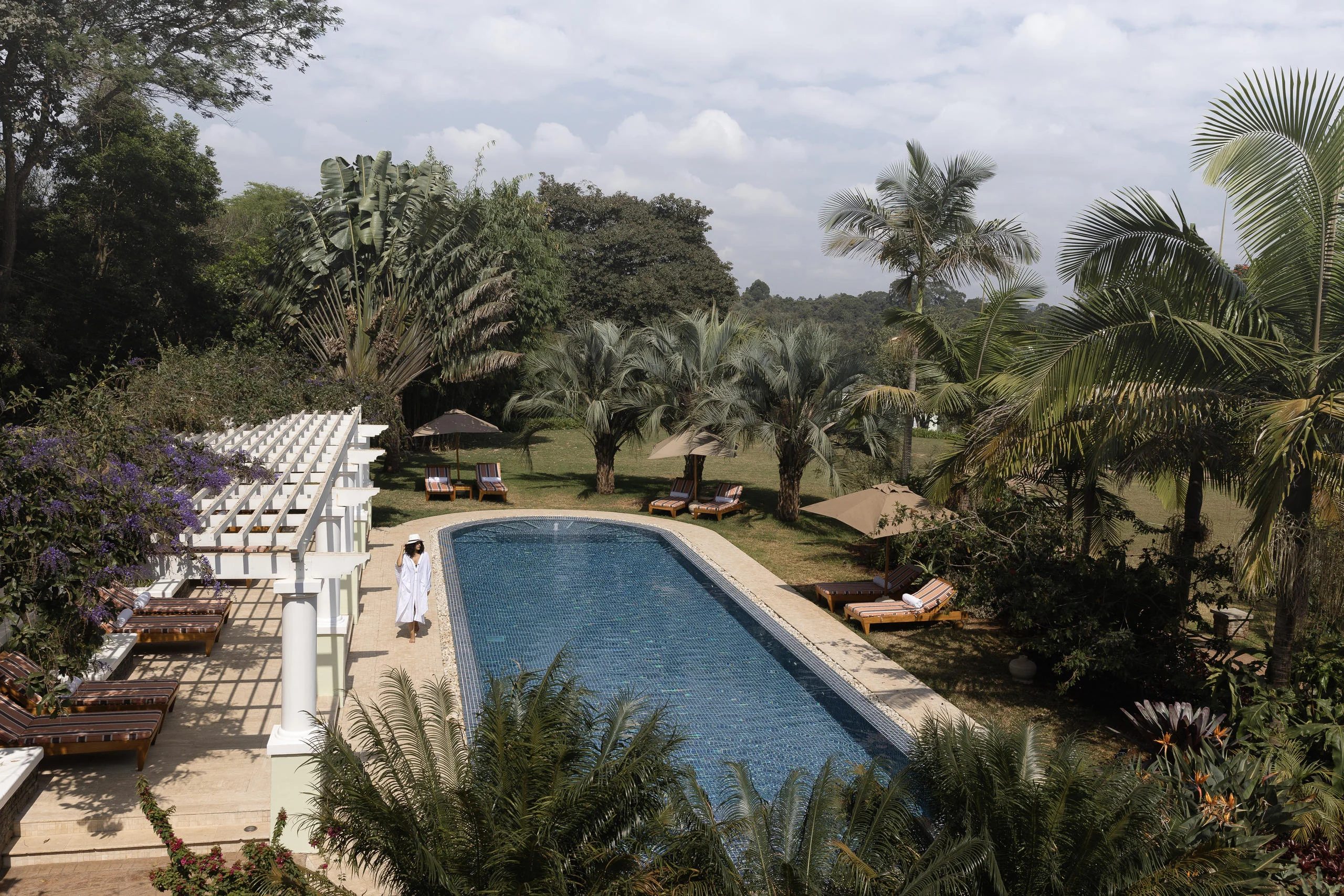 The pool among the gardens with loungers