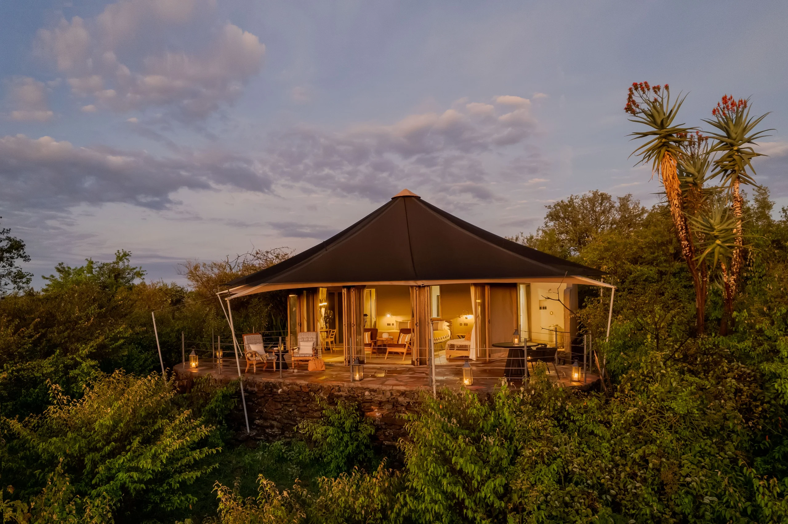 A tent among the trees at dusk