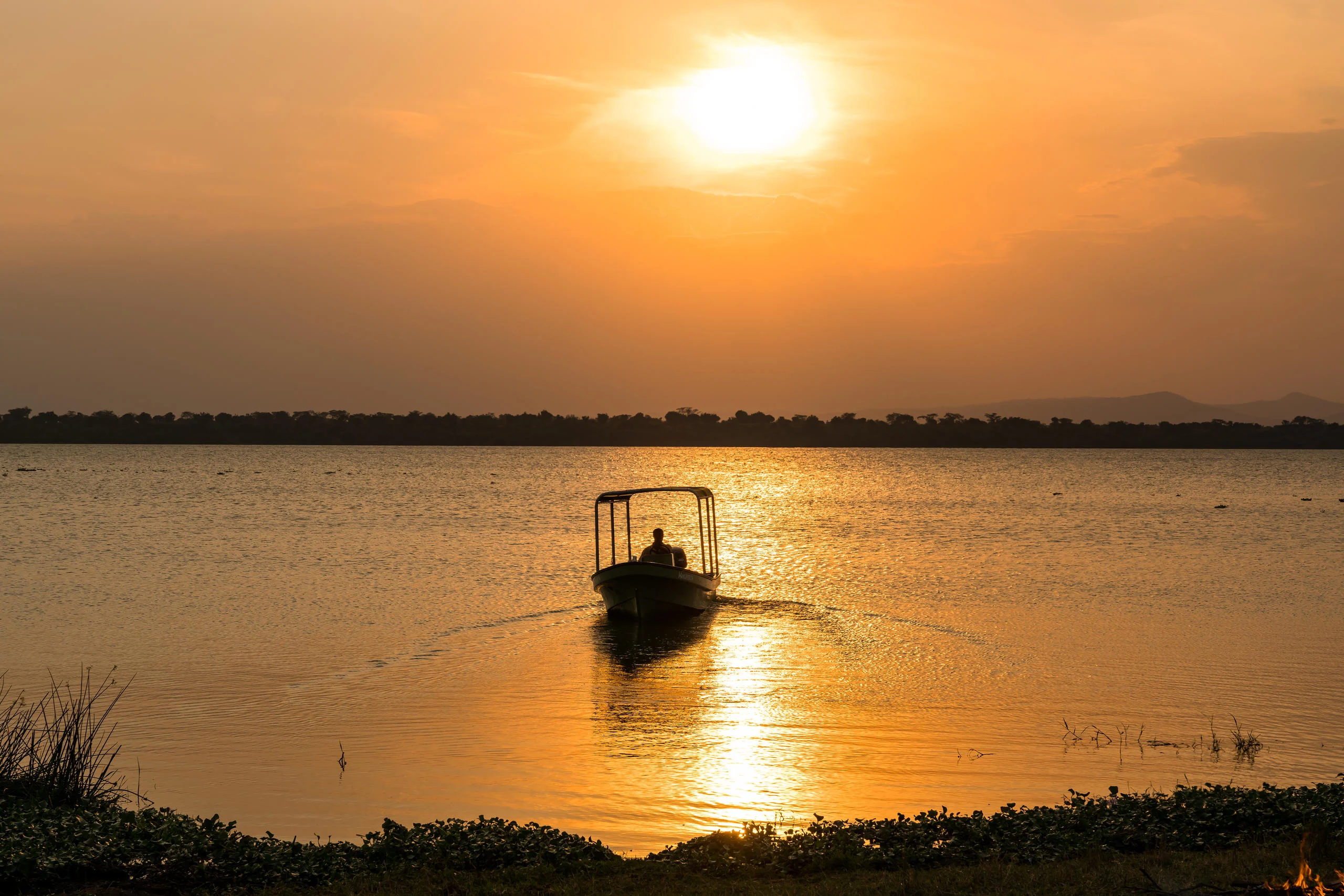 A boat on the lake at sunset