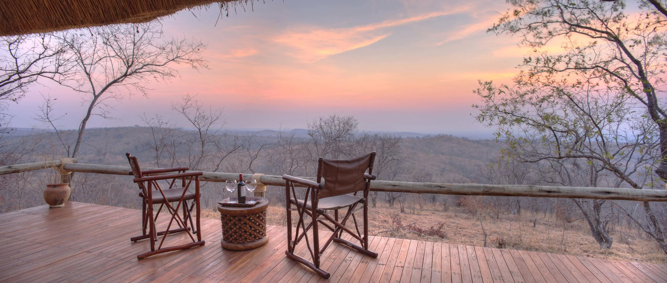 Chairs on a deck at dusk, looking over the valley