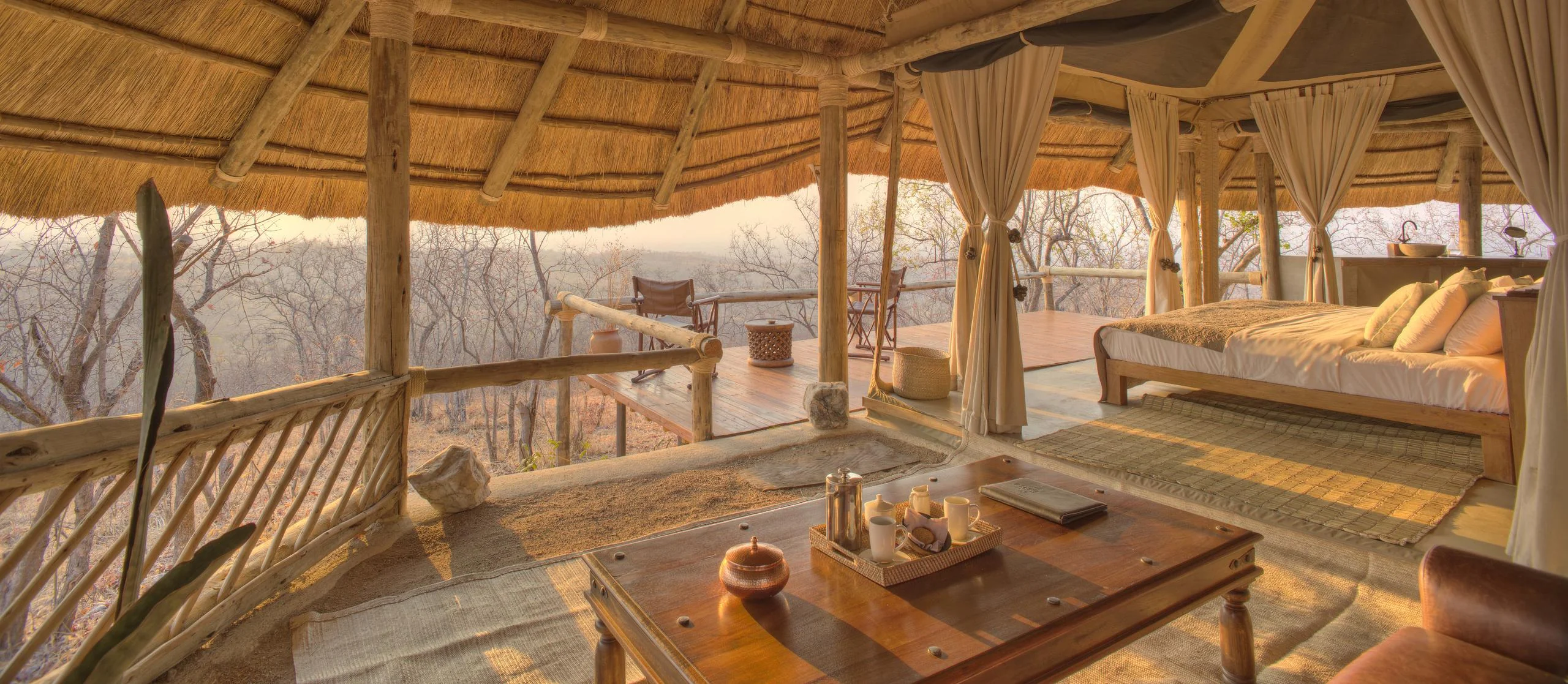 The sitting area of a guest room under thatch