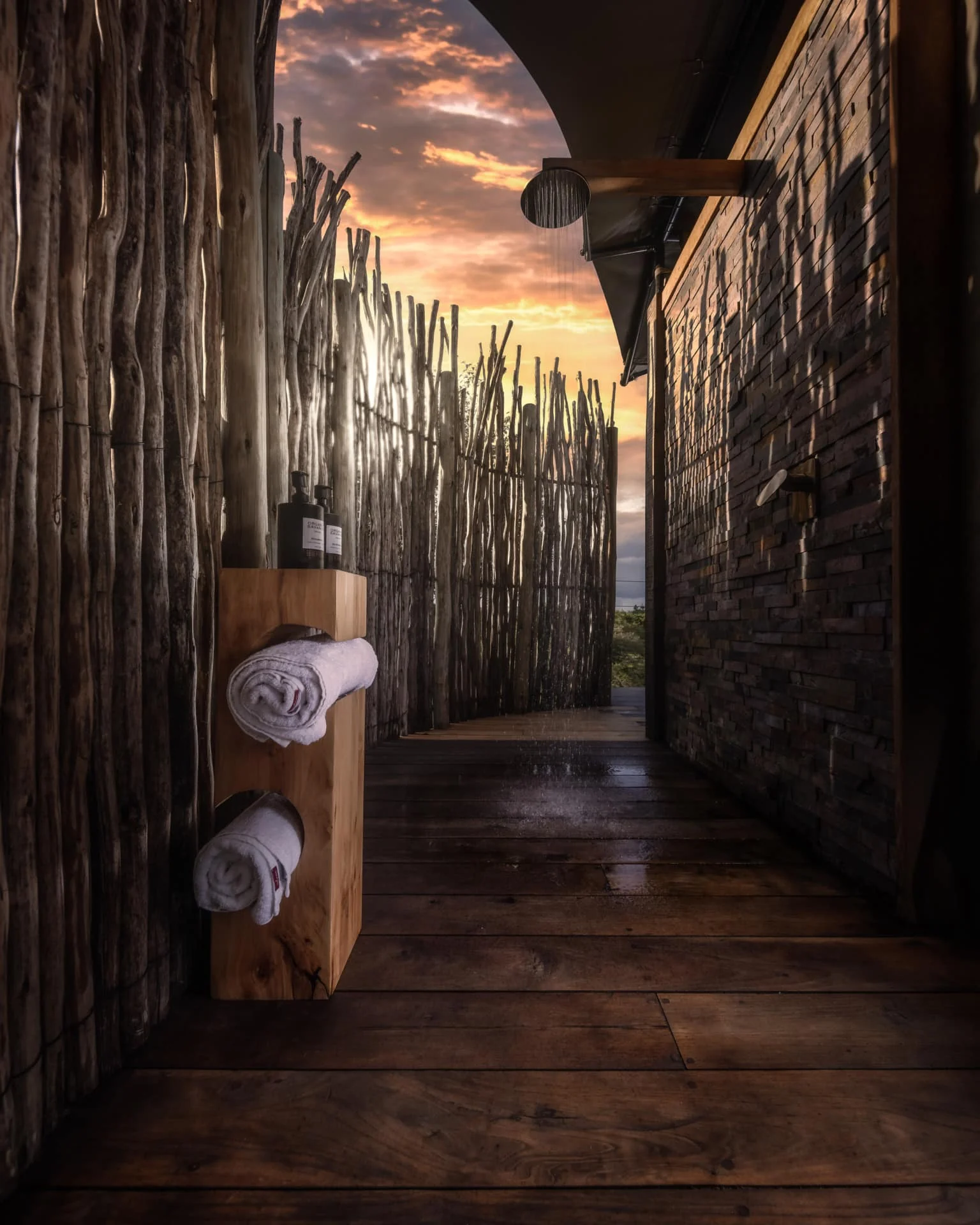 An outdoor shower with a view of the sunset