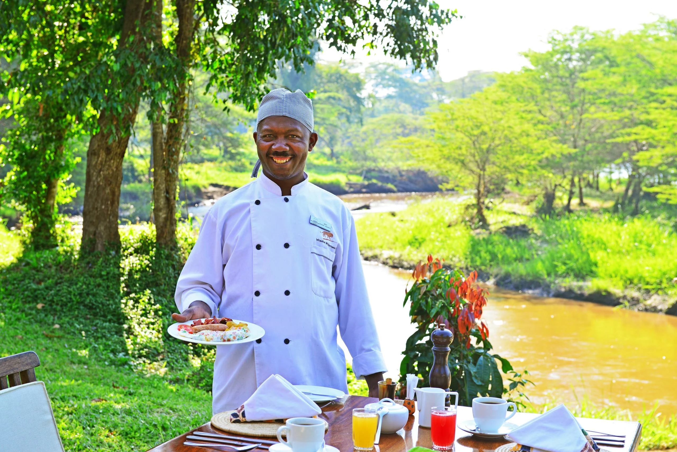 A chef serving breakfast beside the river