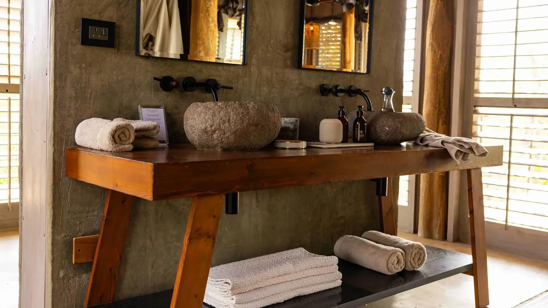 The bathroom with twin basins and rolled towels