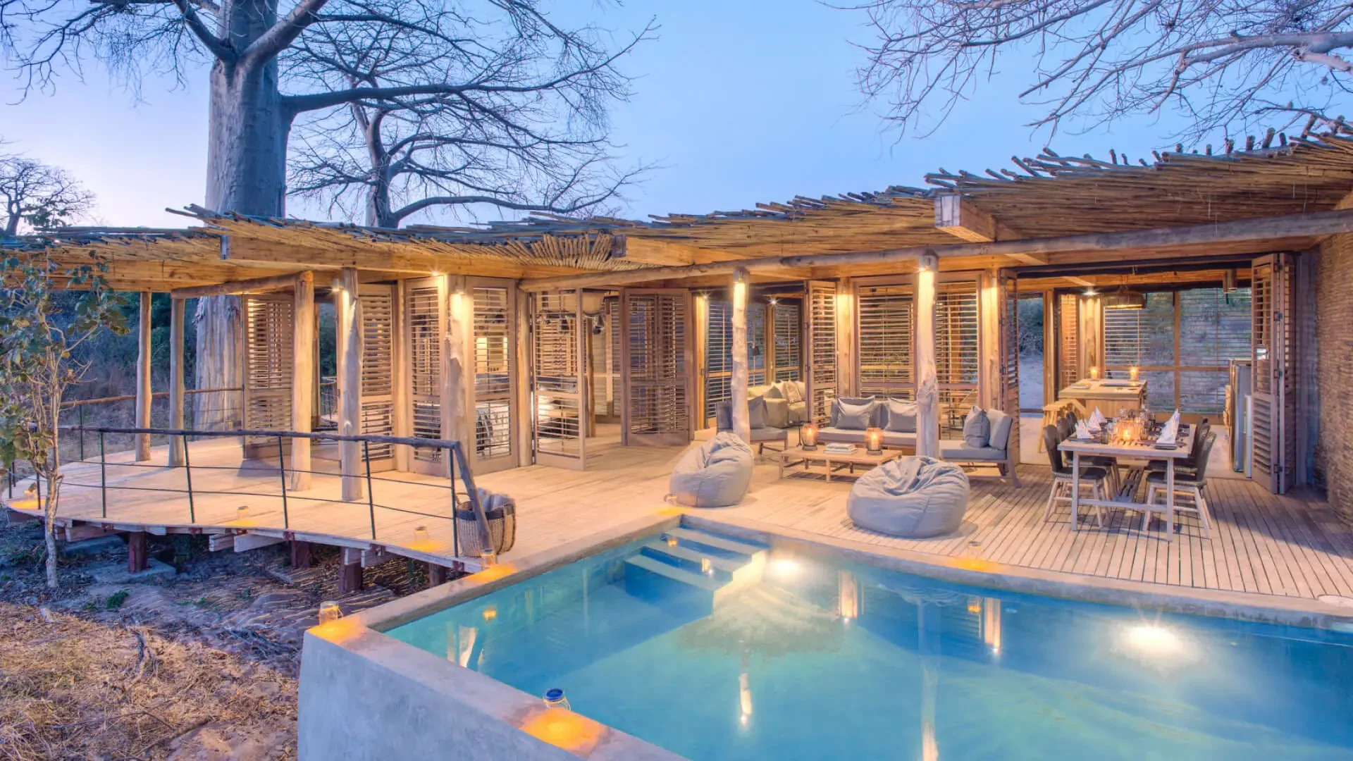 The house and pool lit in the evening