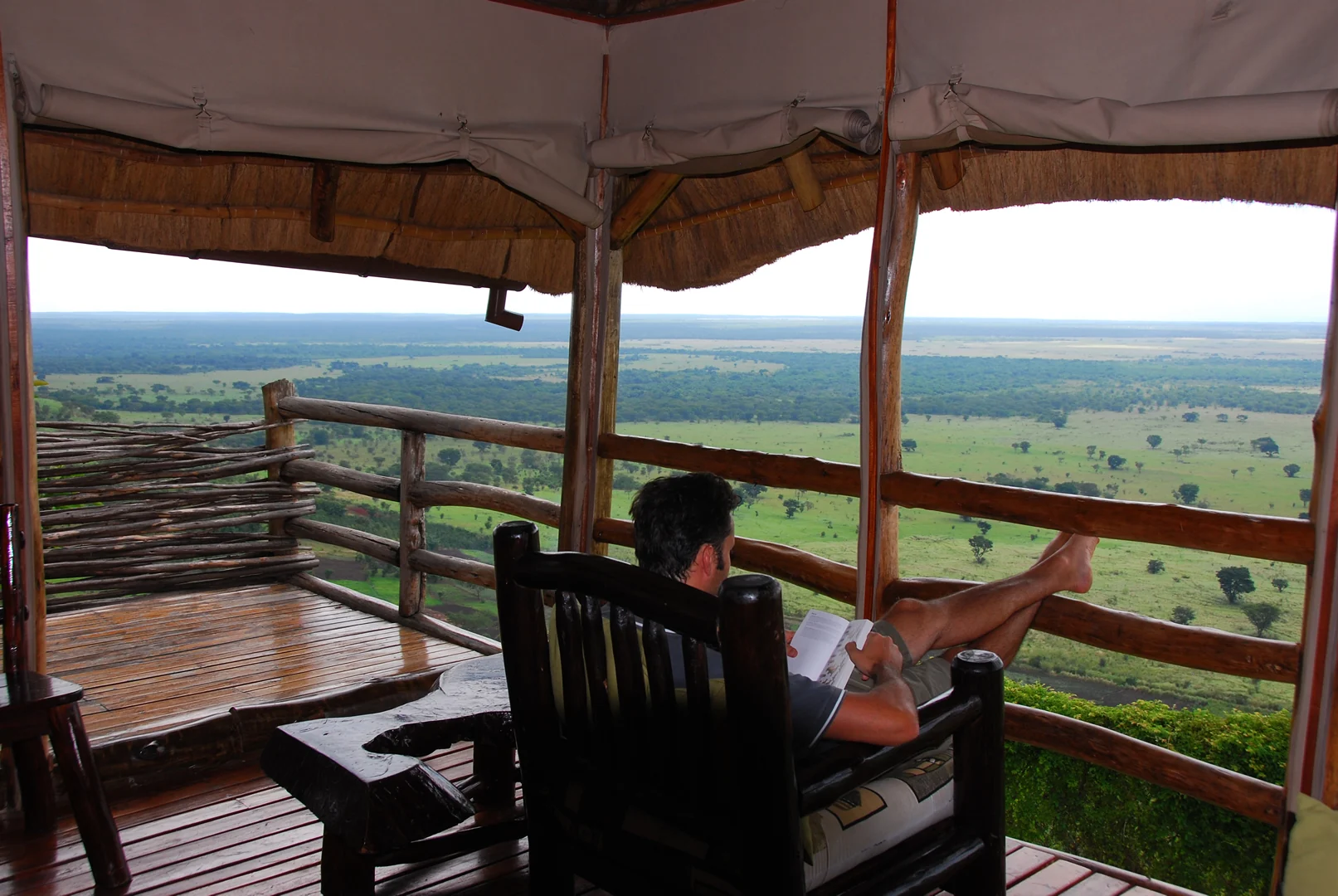 A guest reading on a cottage deck above the plains