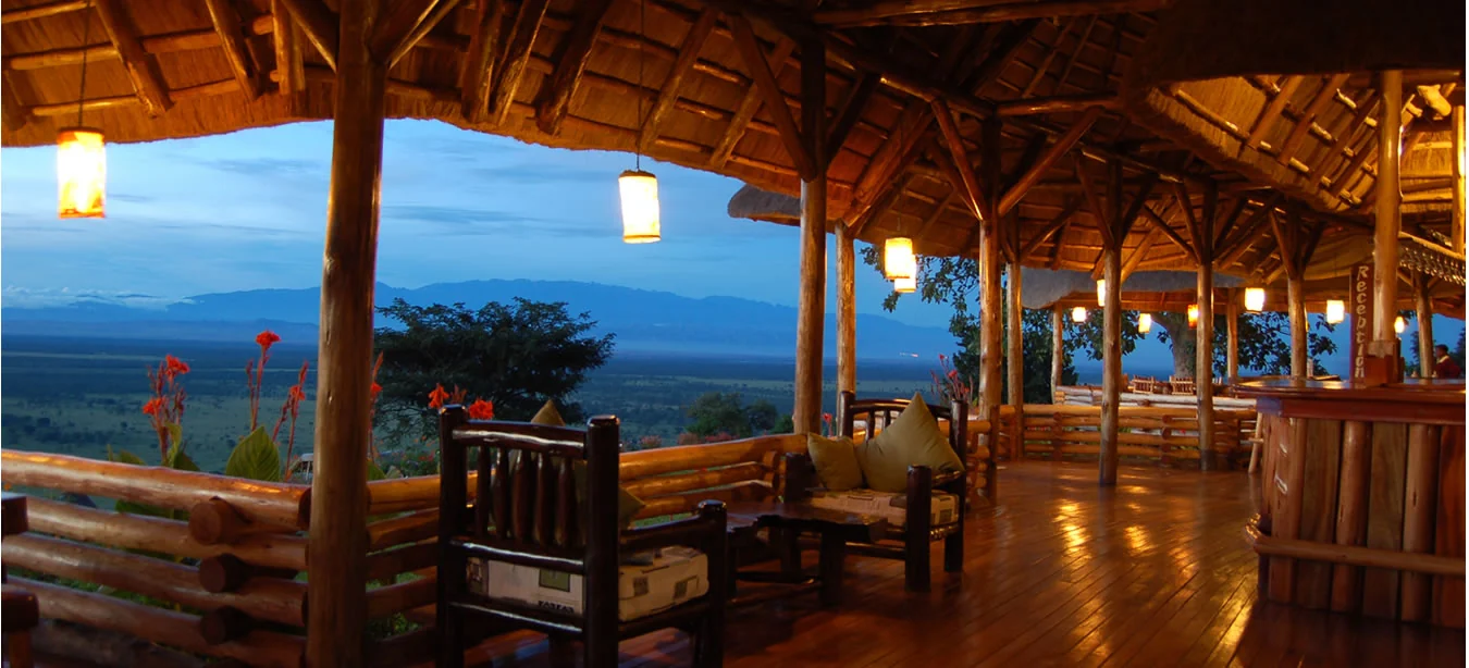 The lounge and dining area under thatch at dusk
