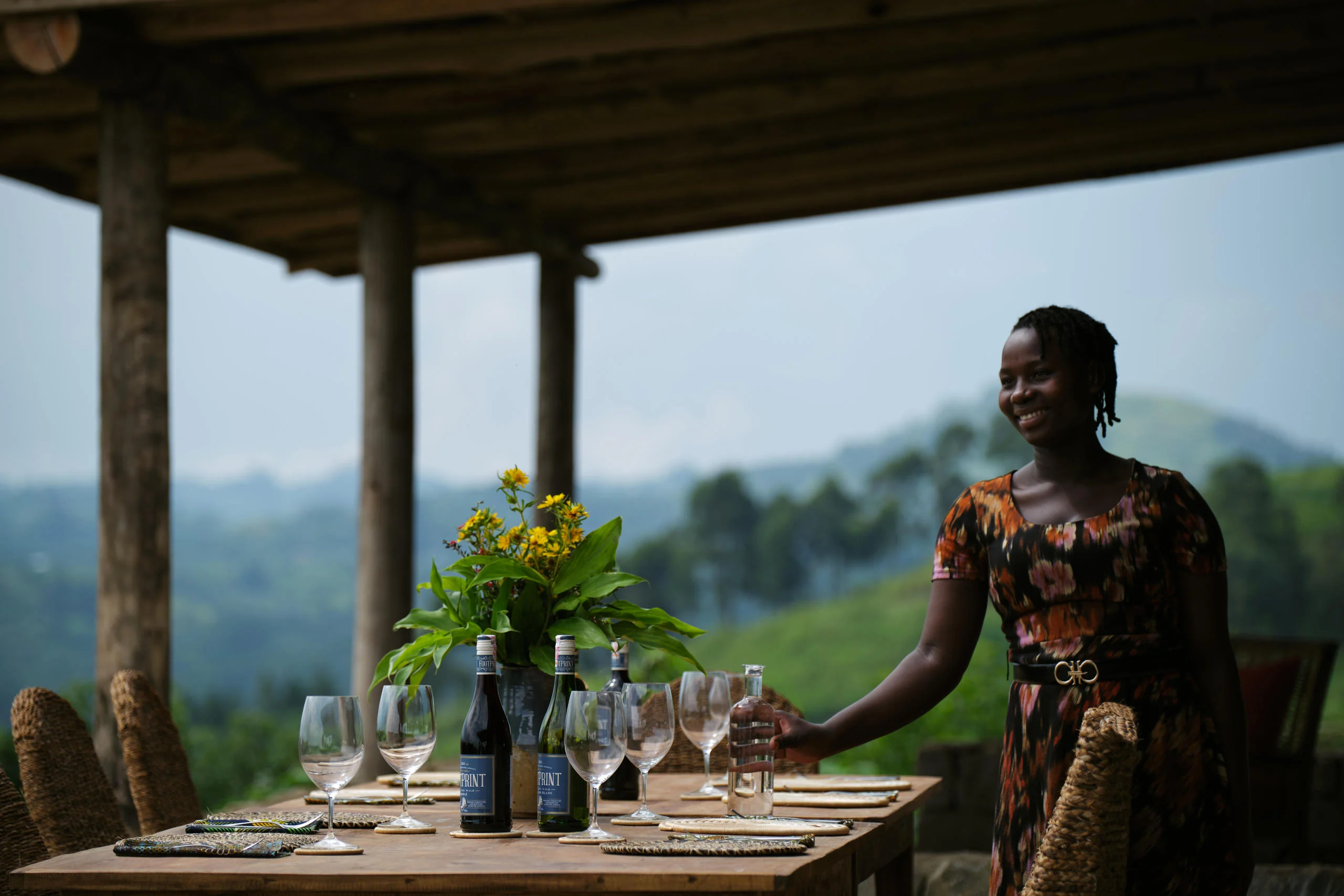 A member of staff beside a table laid on the veranda