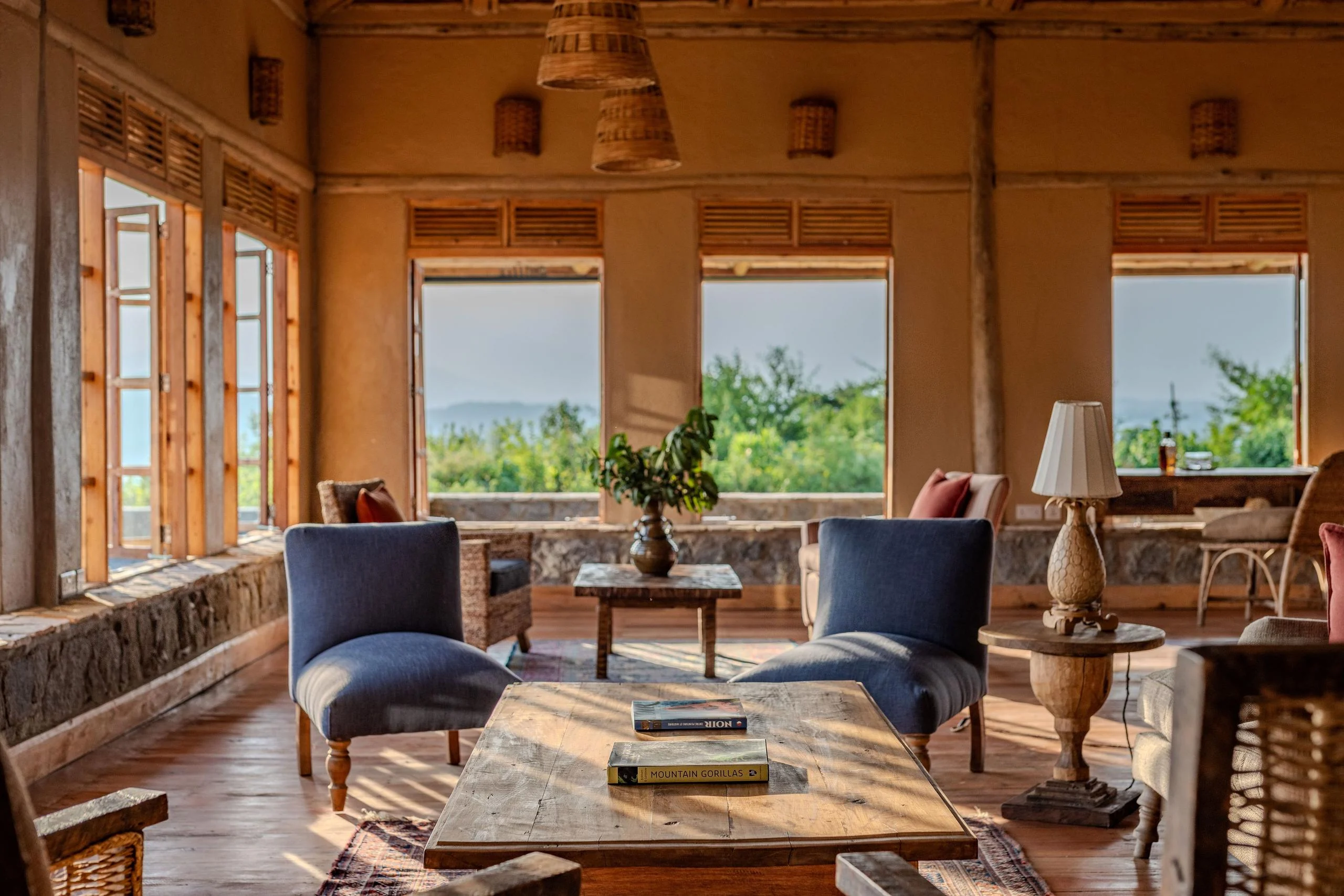 The lounge with armchairs and windows onto the hills