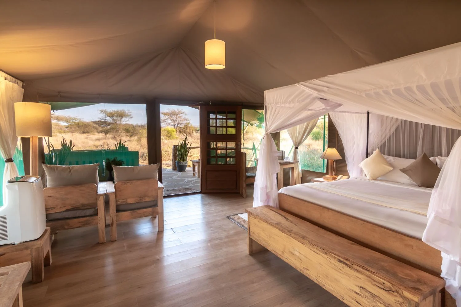 A tent bedroom with a four-poster bed