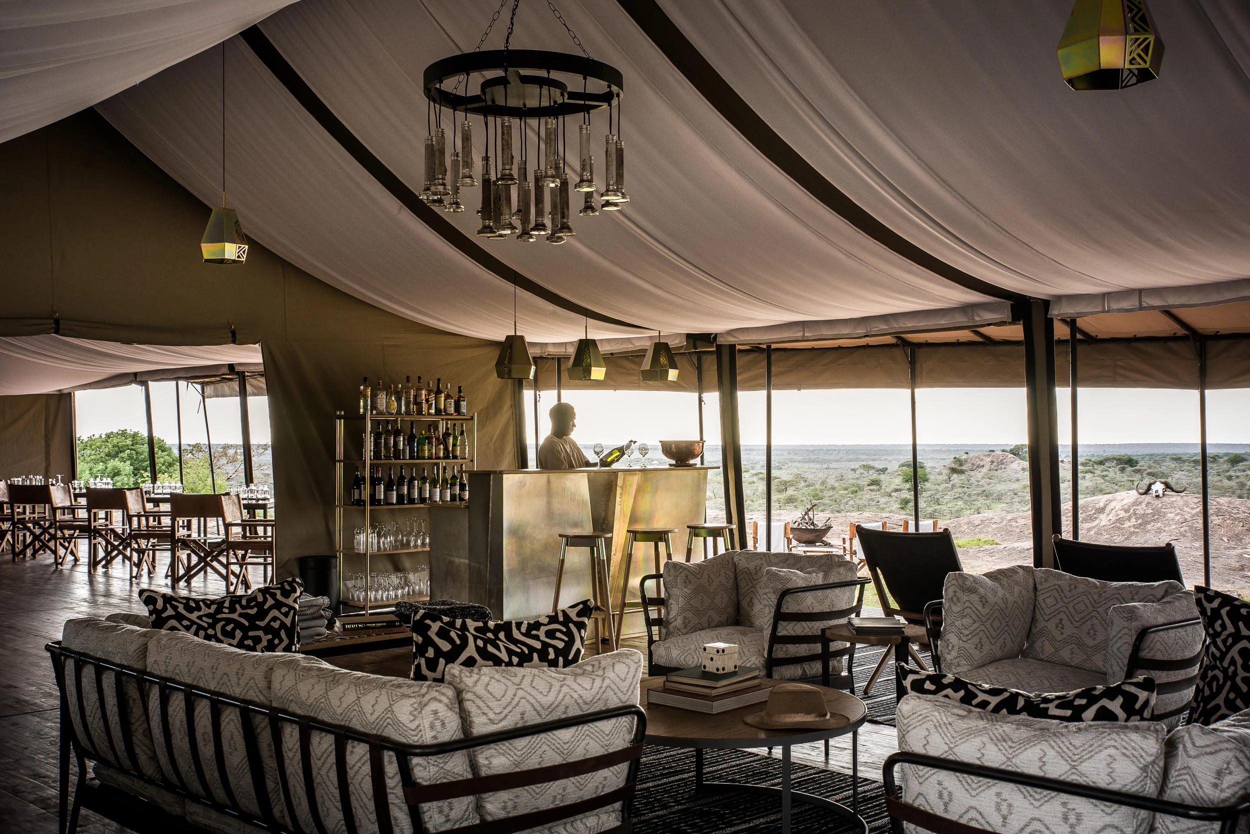 The lounge tent with a chandelier and patterned cushions