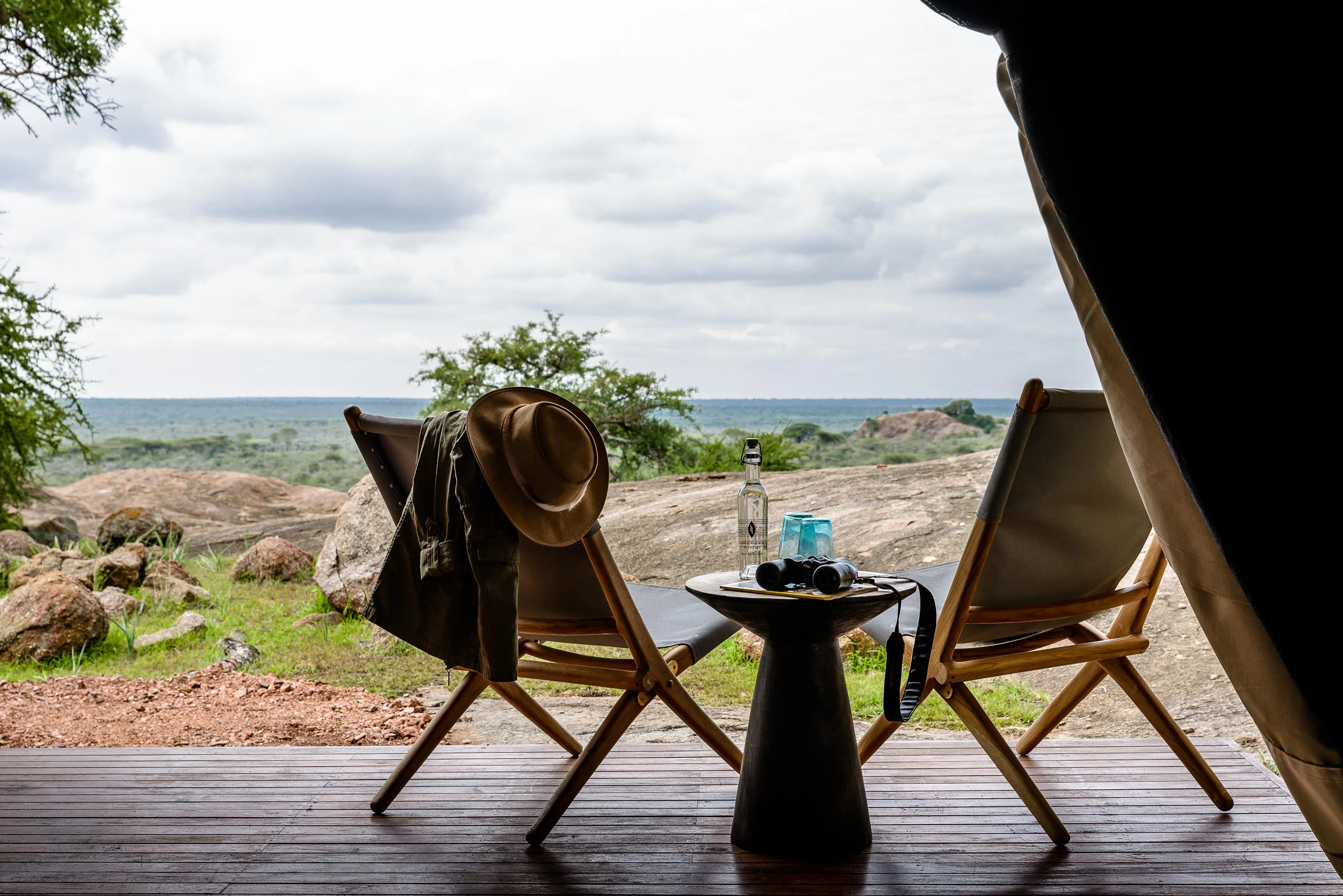 Chairs on a tent deck looking over the plains