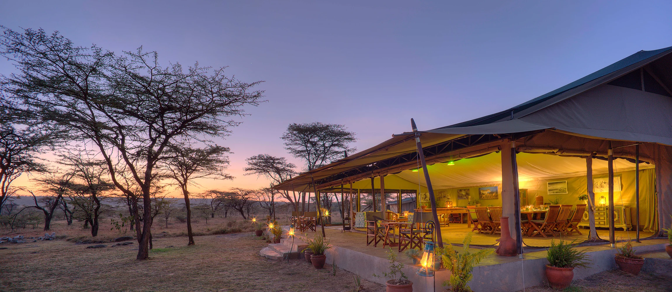 The main tent lit at dusk