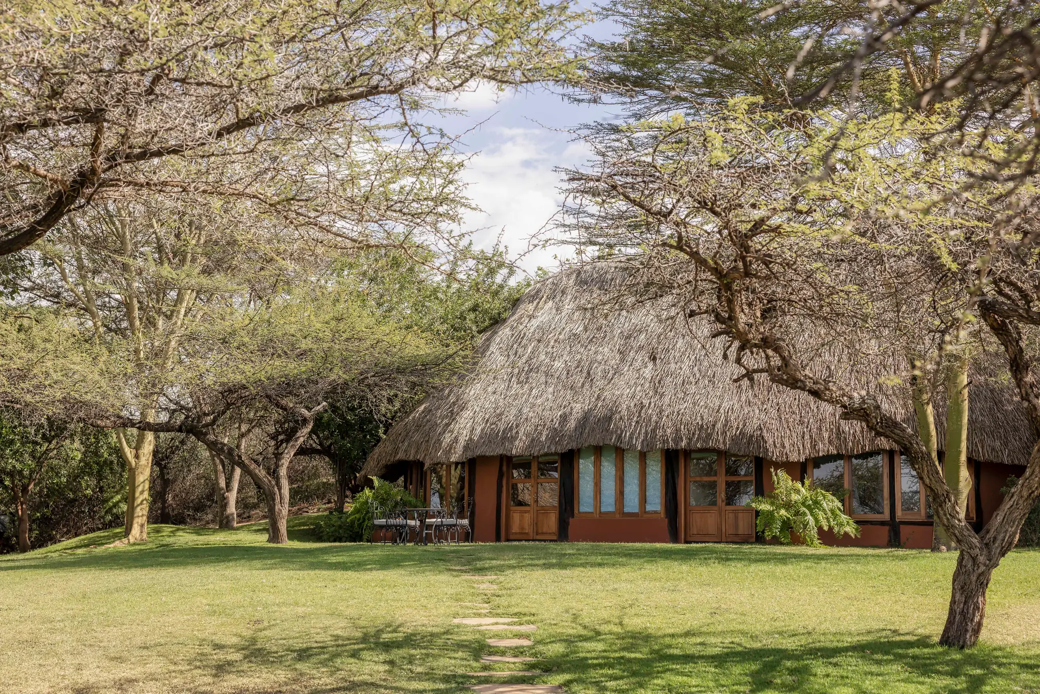 A thatched cottage beside the gardens at Kifaru House Lewa
