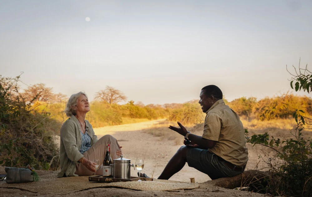 A guest and a guide on a walk at sunset