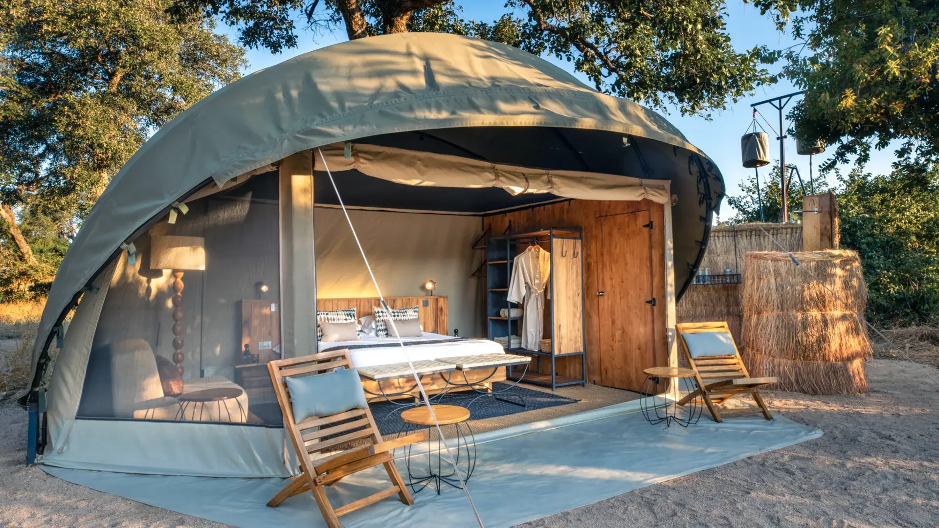 A dome-shaped tent with its front open to the deck