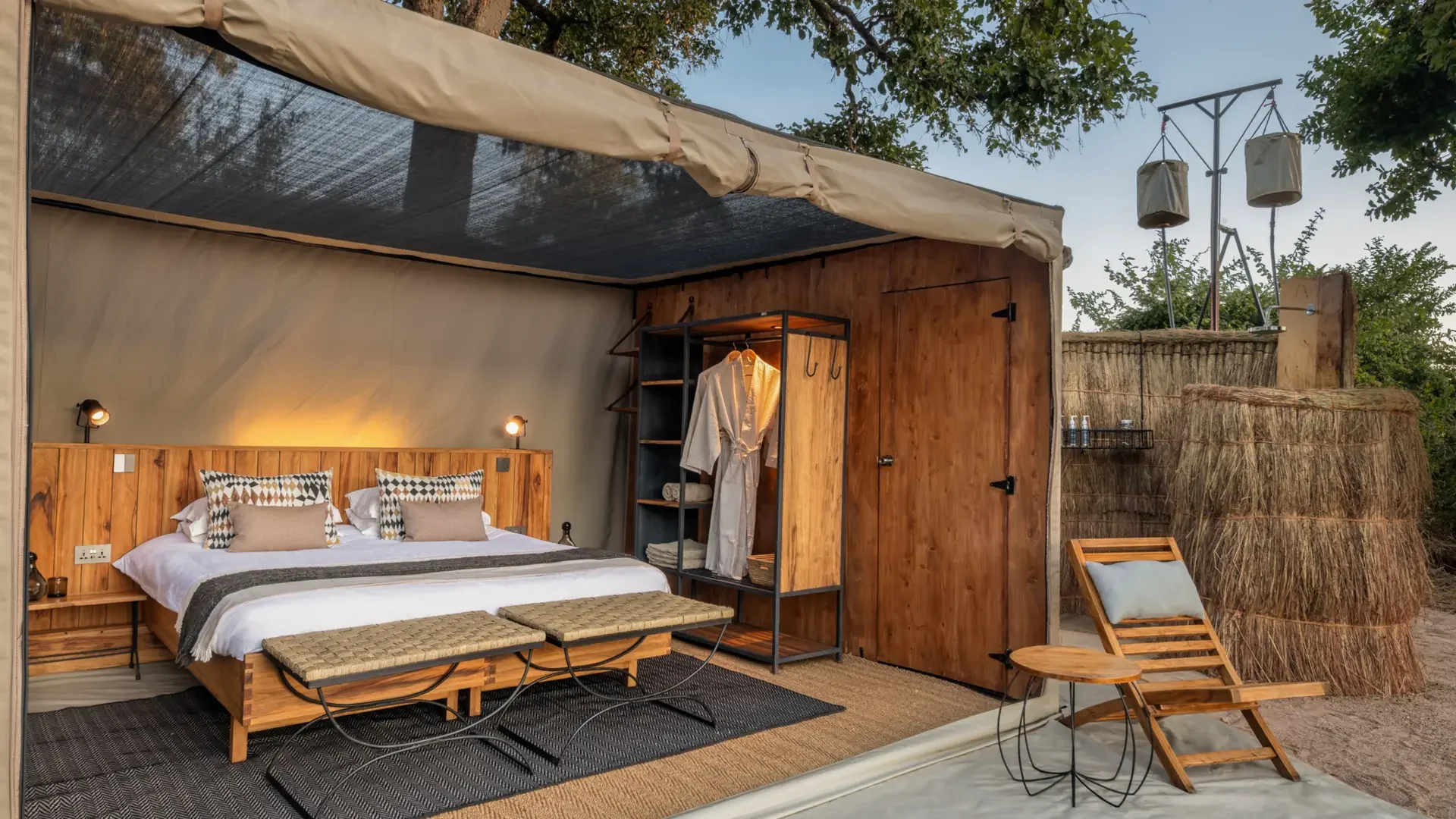 A tent bedroom with the front rolled up