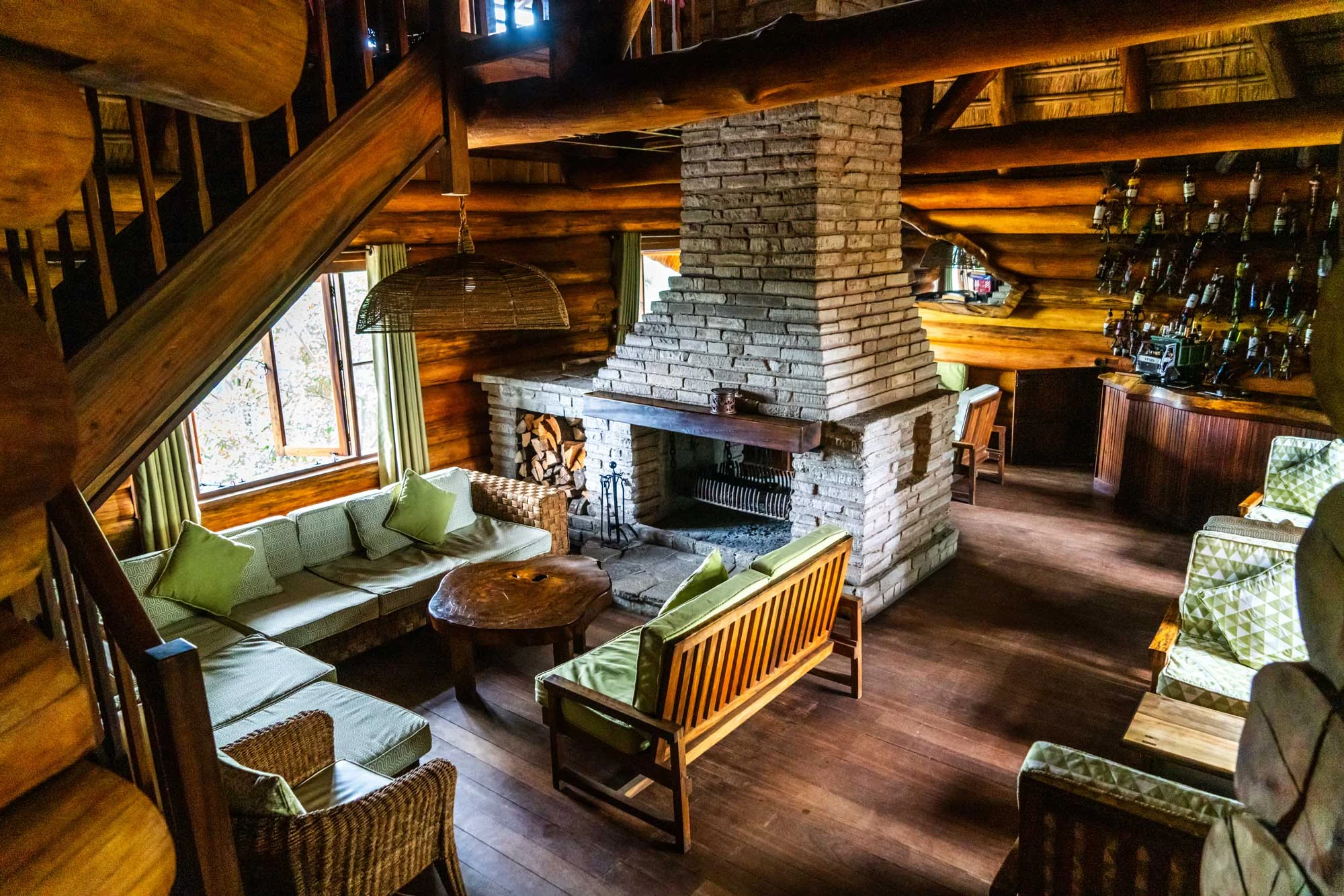 The lounge with a stone fireplace and timber beams