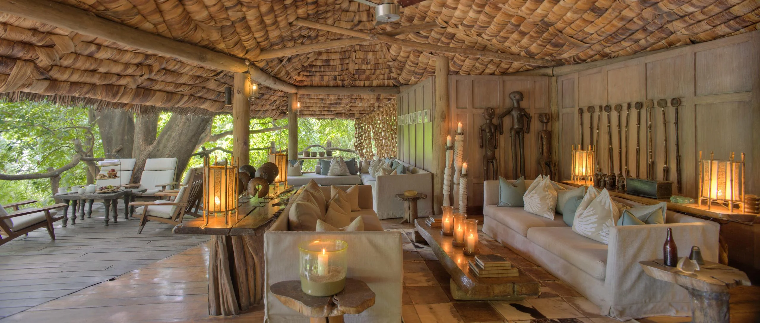 The lounge under thatch, lit by lanterns