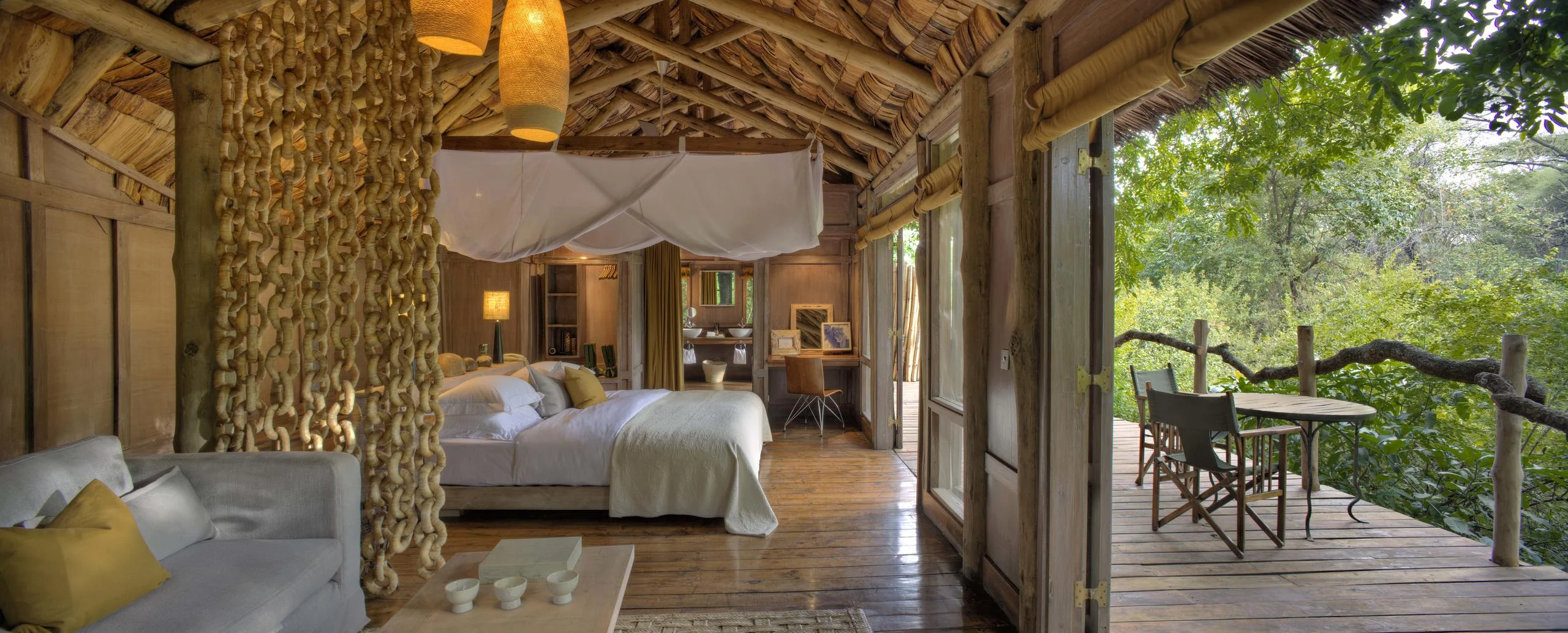 A treehouse bedroom with a draped bed