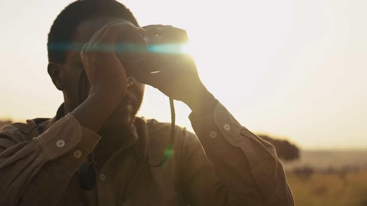 A guide with binoculars in the morning light