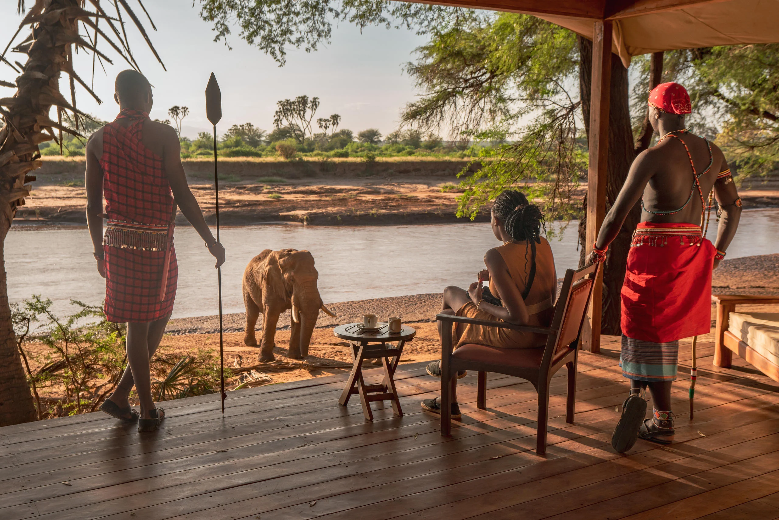 Samburu guides and guests watching an elephant from the deck
