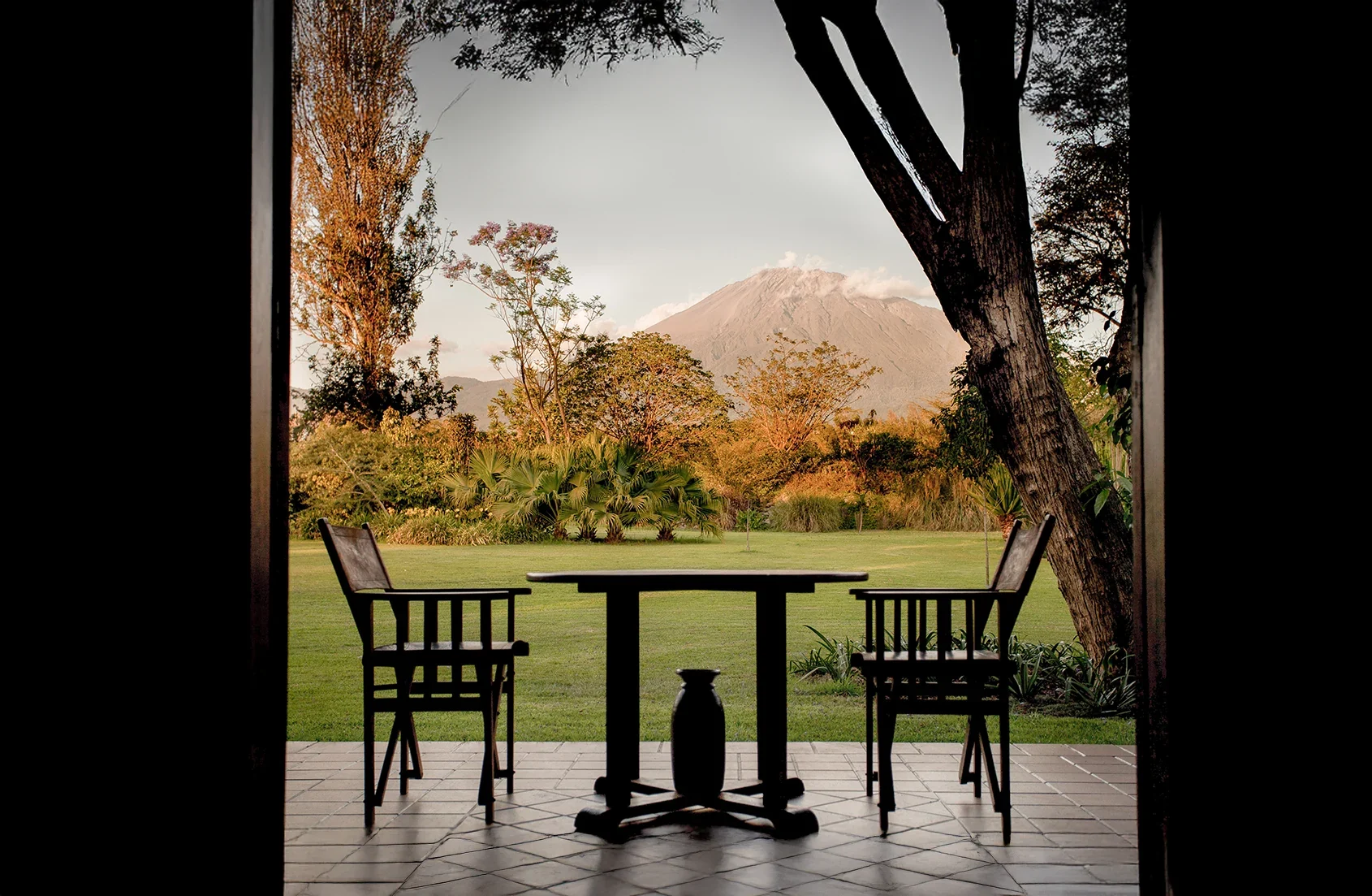 A table on the veranda looking towards the mountain