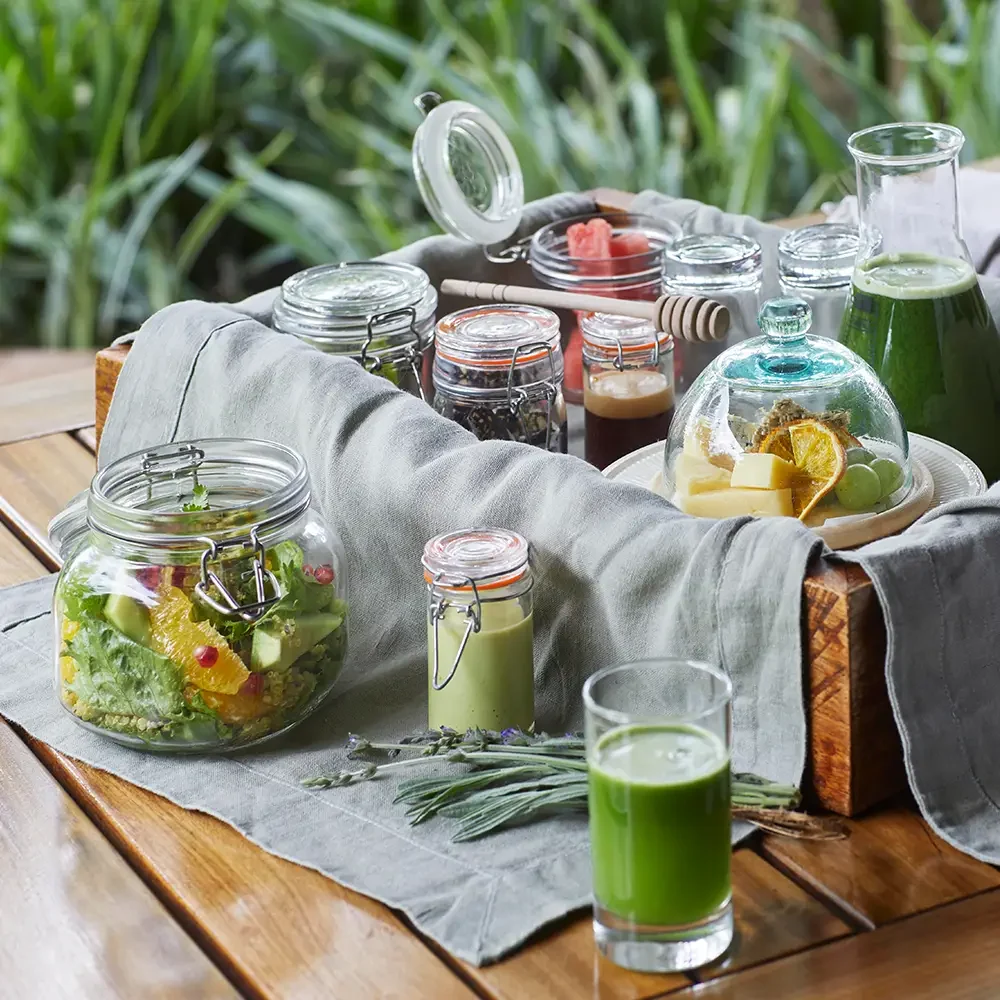 Jars of preserves and juices on a garden table